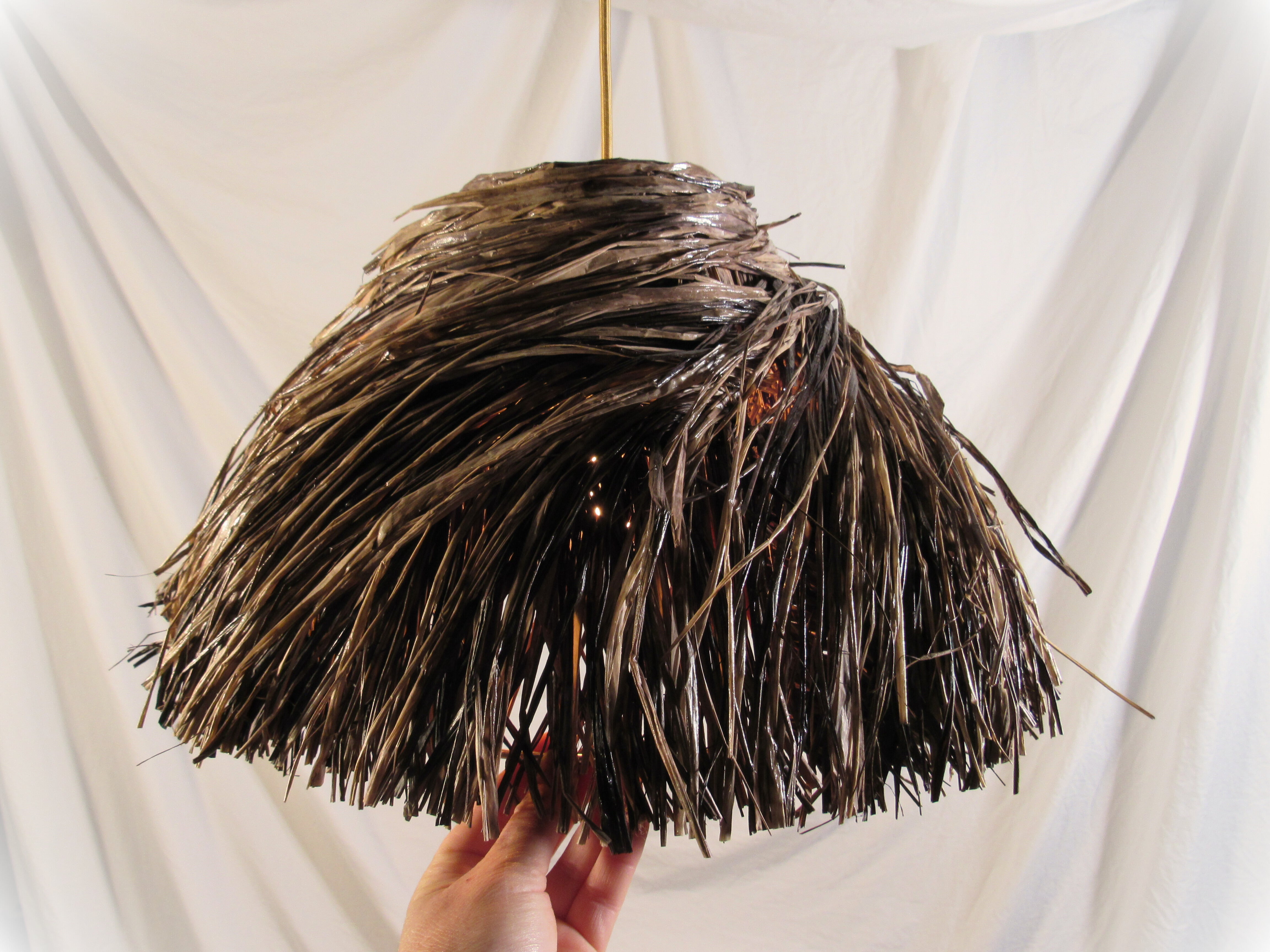 The bird's nest lampshade photographed against a neutral background