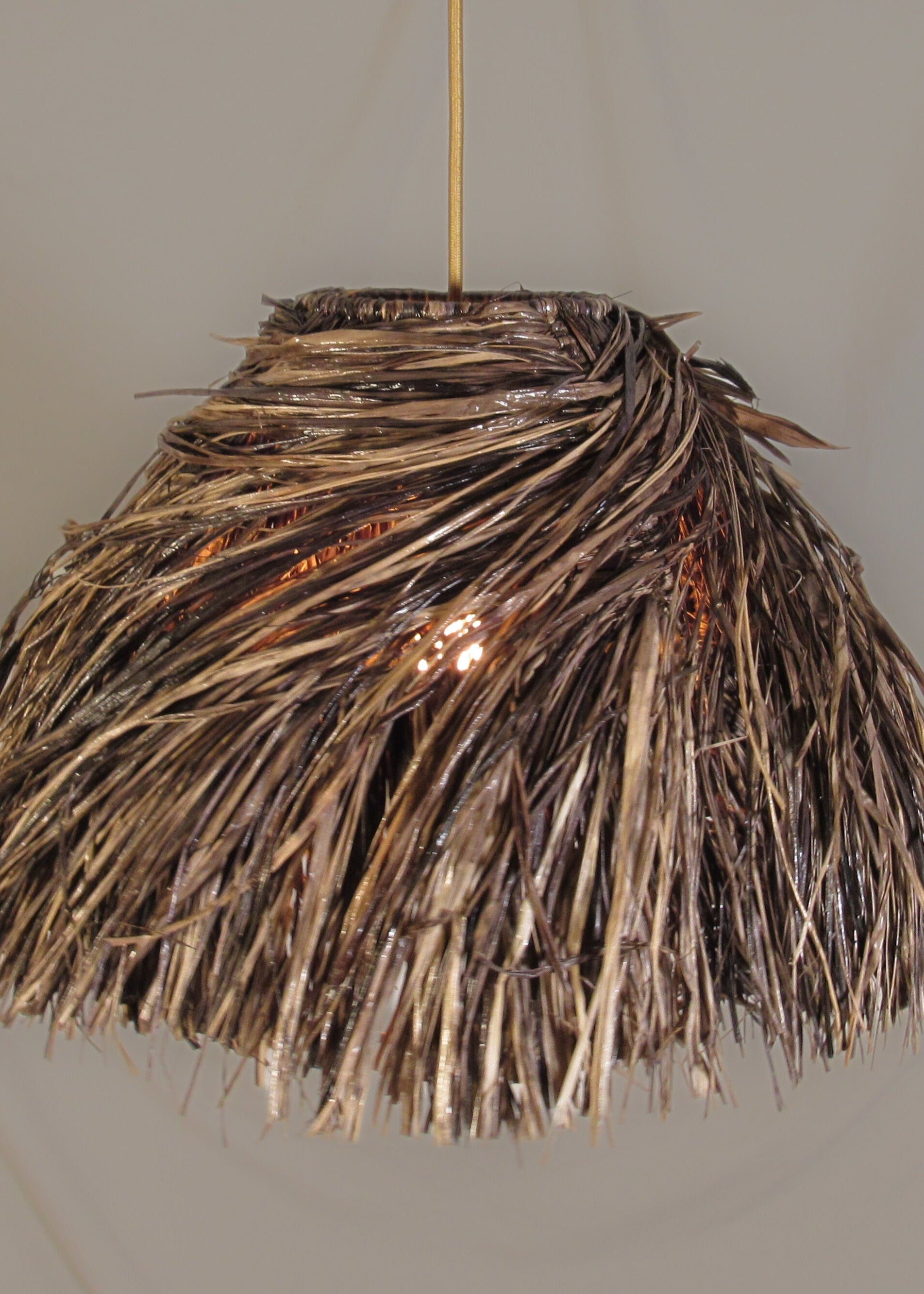 The bird's nest lampshade photographed against a neutral background