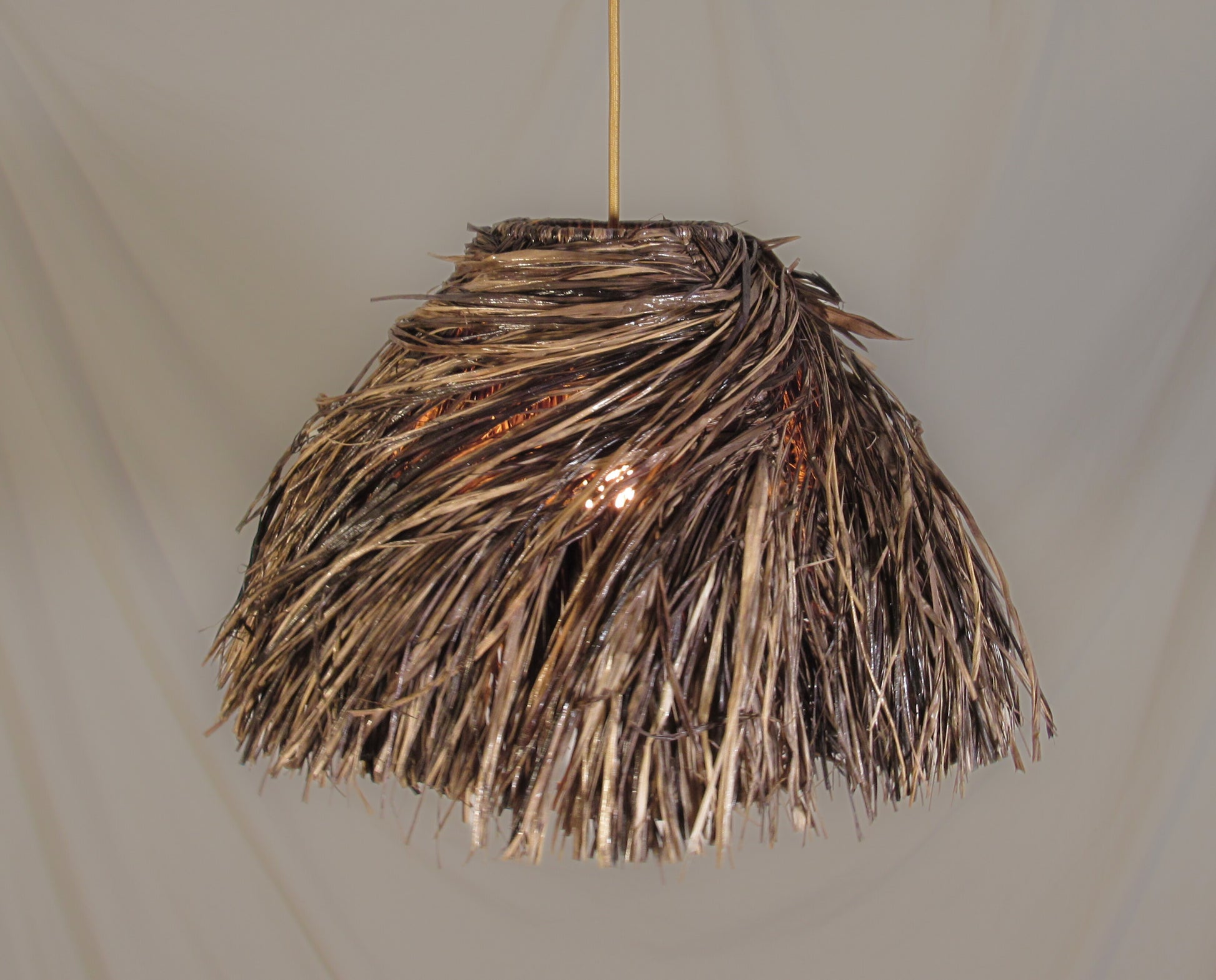 The bird's nest lampshade photographed against a neutral background