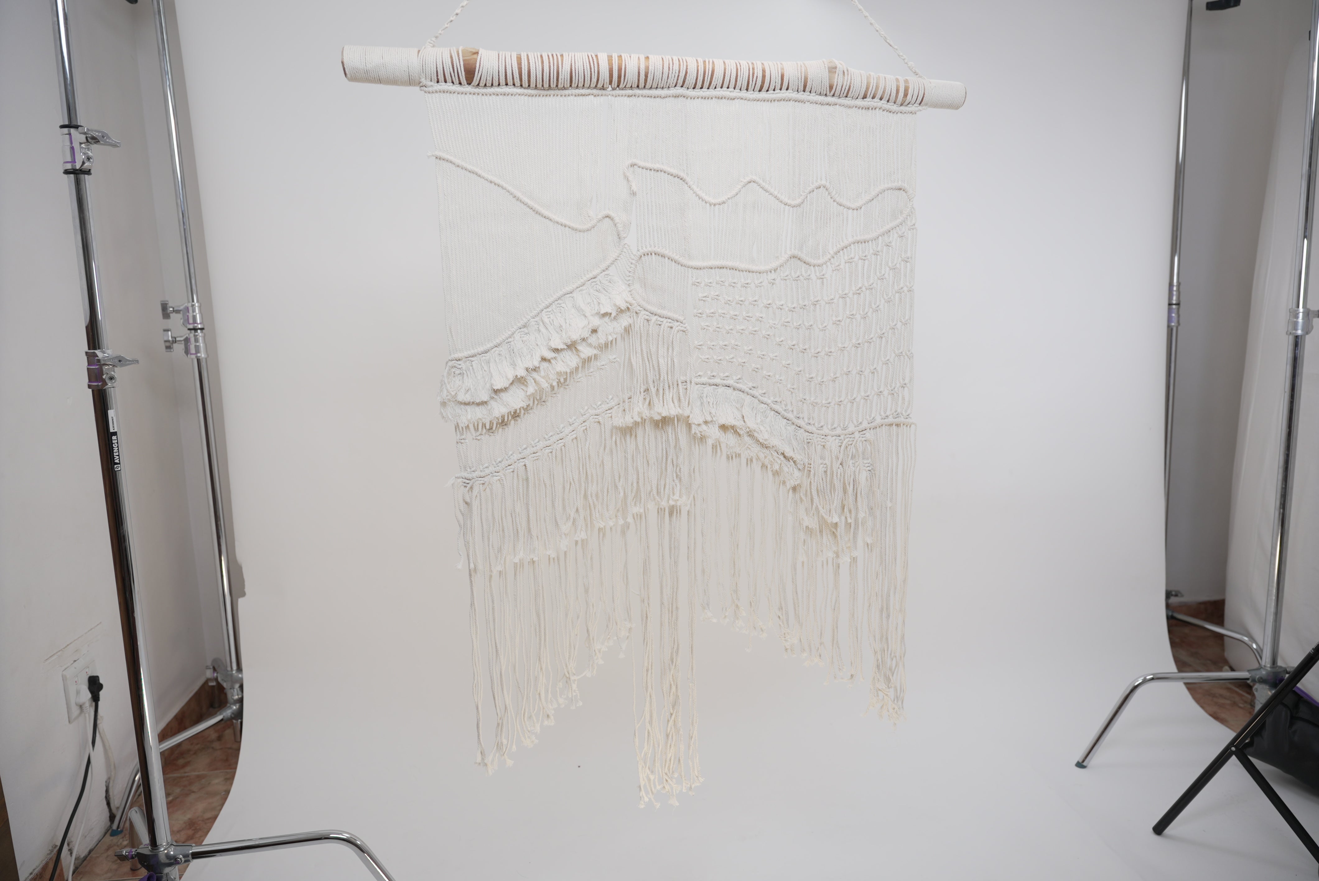 Two of the garlic gourds photographed on a side table with afternoon sun on them