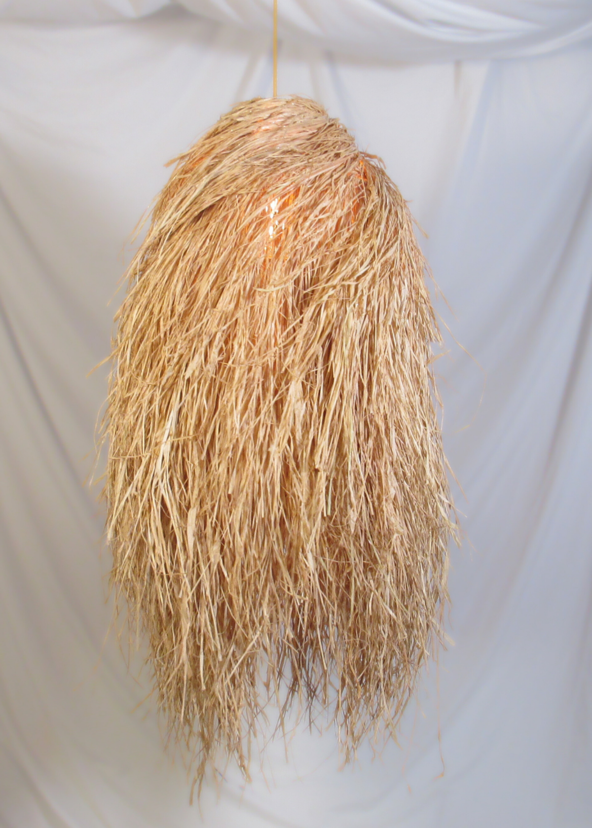 The Bird’s Nest pendant woven with raffia on stainless steel frame locally made and customisable
