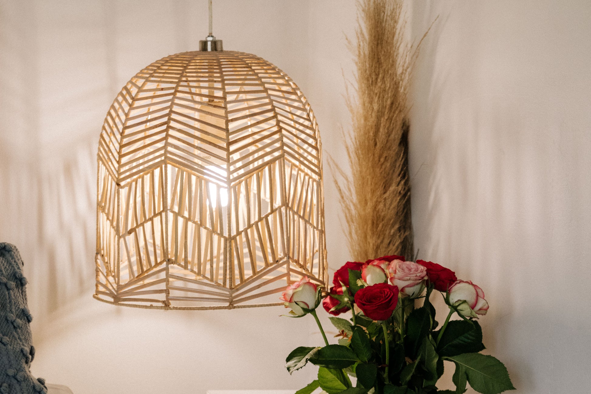 The Circus pendant woven from rattan peel on stainless steel frames locally made and customisable. The small here as a hanging bedside lamp.
