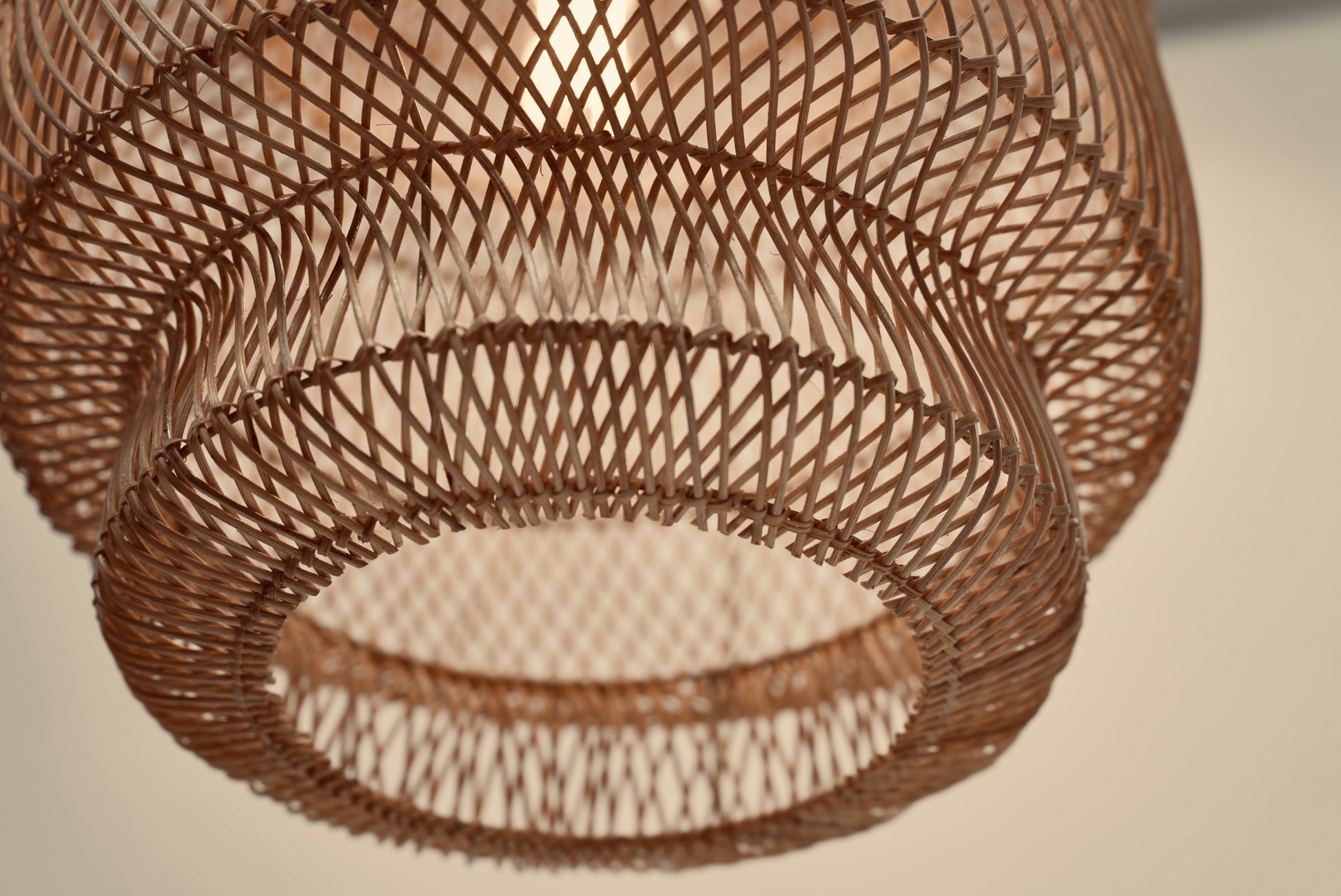 Close-up of a woven hanging light with a textured pattern