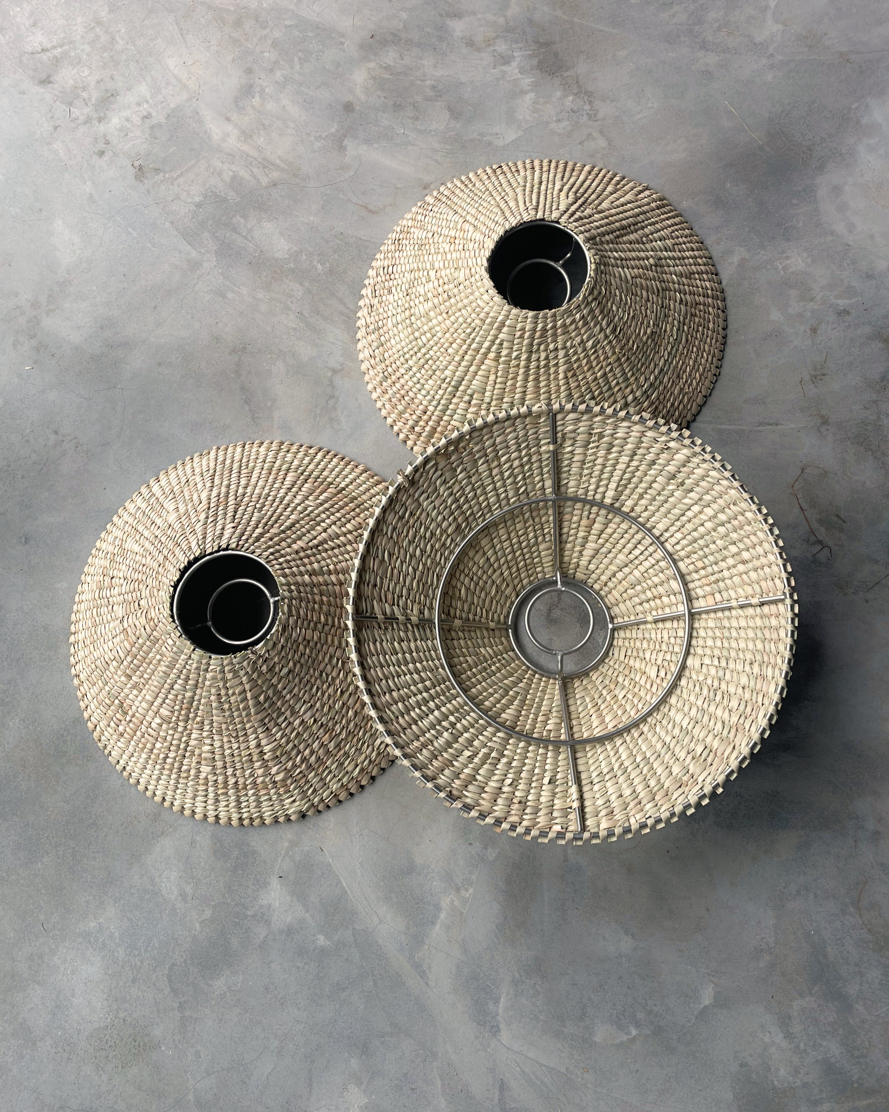 Handmade natural grass pendant hanging light lampshade woven lighting outdoor friendly customisable new modern safari lodge luxury interior on stainless steel frame
Modern interior designer lighting fixtures and lampshades, hand woven, locally made for lodges, restaurants, hotels, interior design projects
Living room statement hanging light with dense tight weave 
