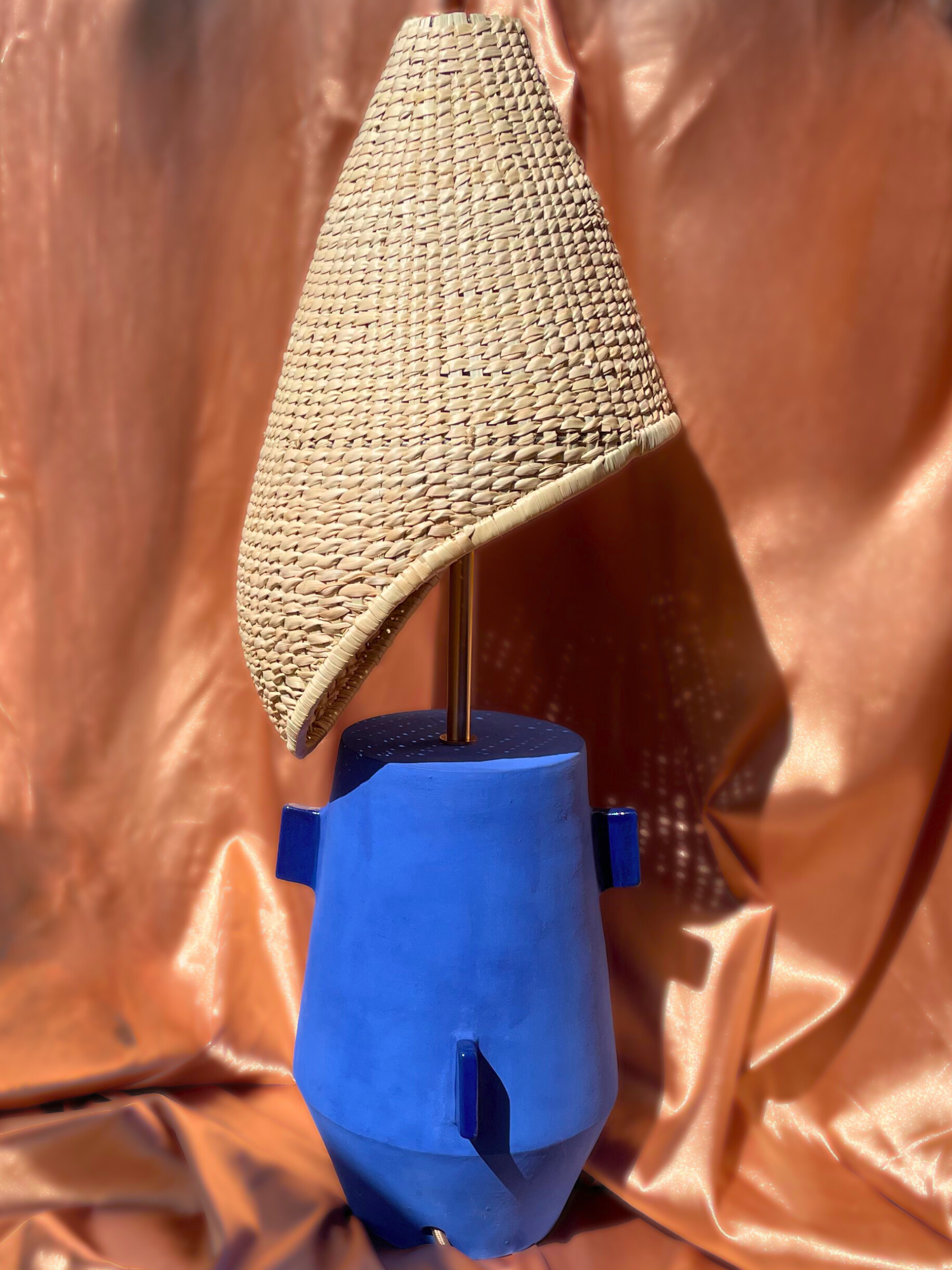 Lamp with a wicker shade and blue base  brass fixtures custom cord