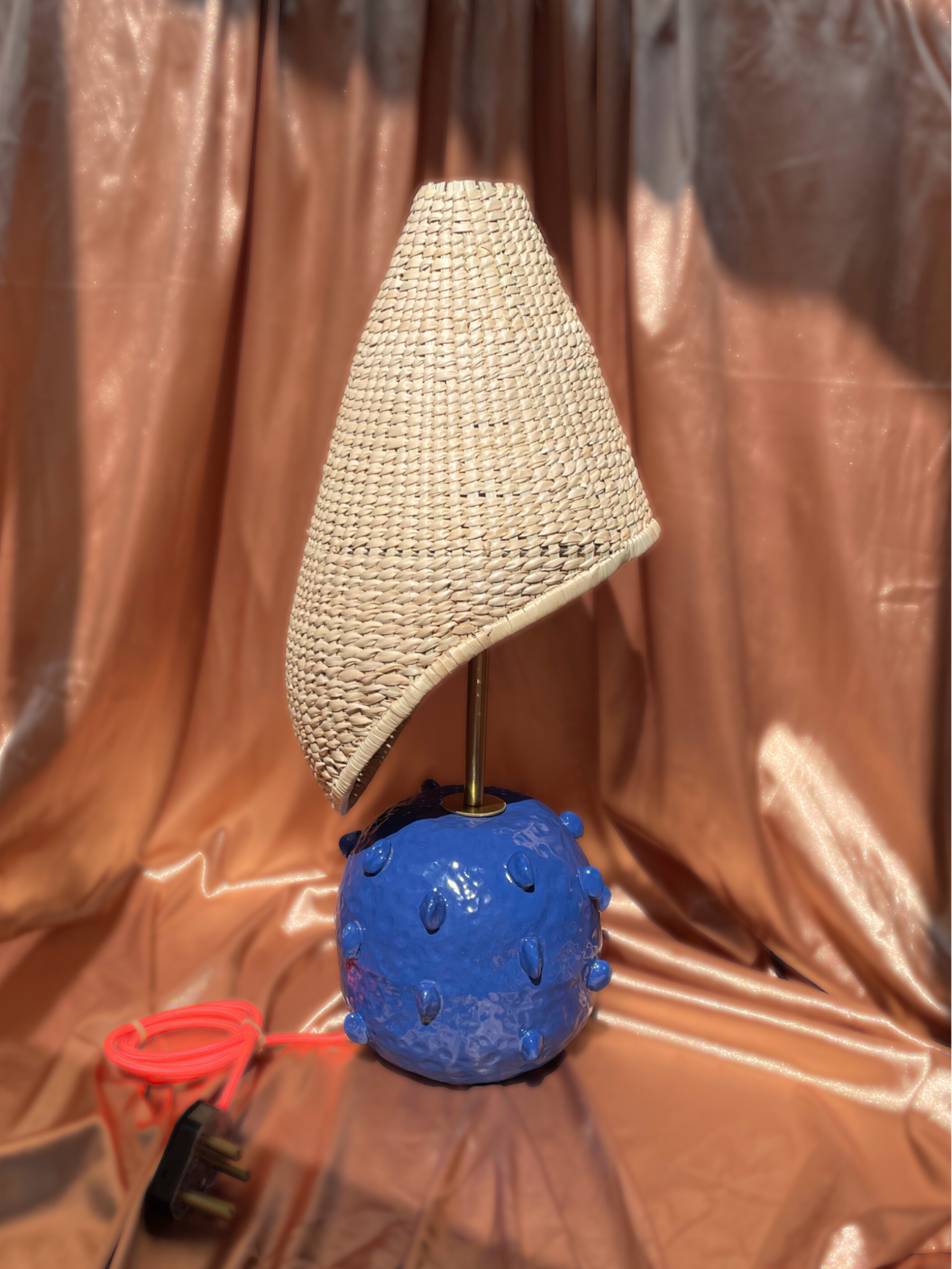 Lamp with a textured blue base and wicker shade brass fixtures custom cord