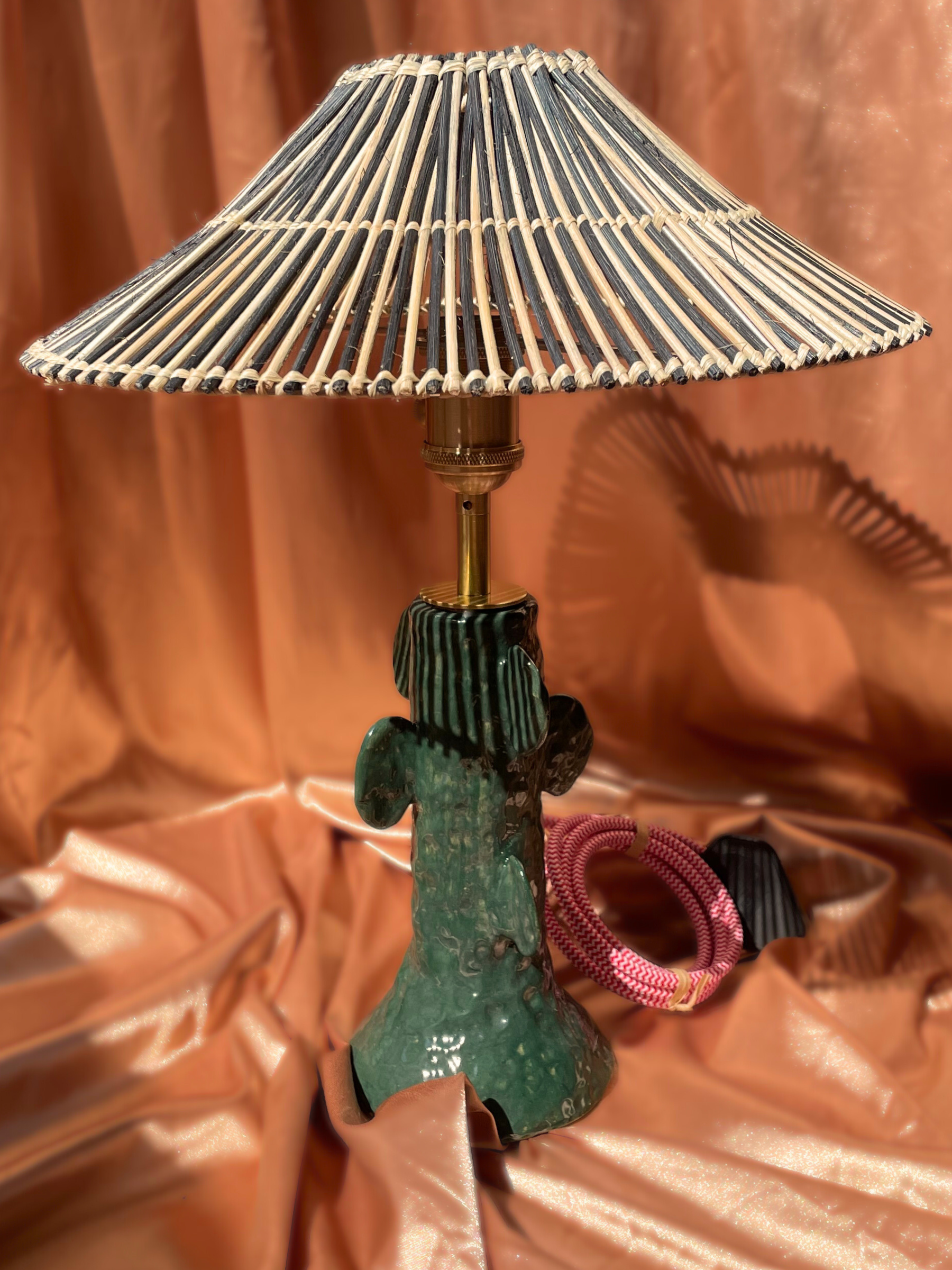Lamp with a pleated shade on a reflective surface