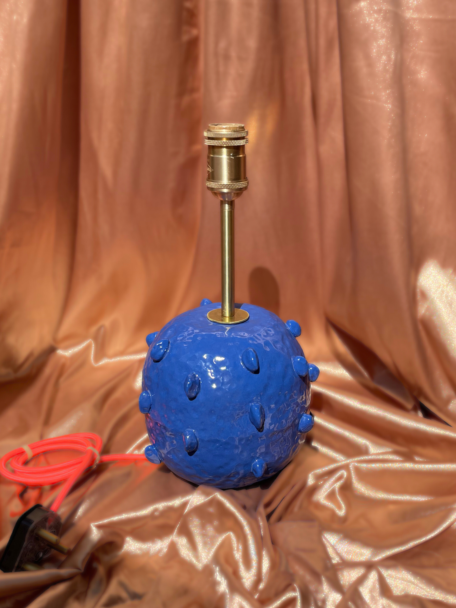 Blue textured ball with a gold lampshade 