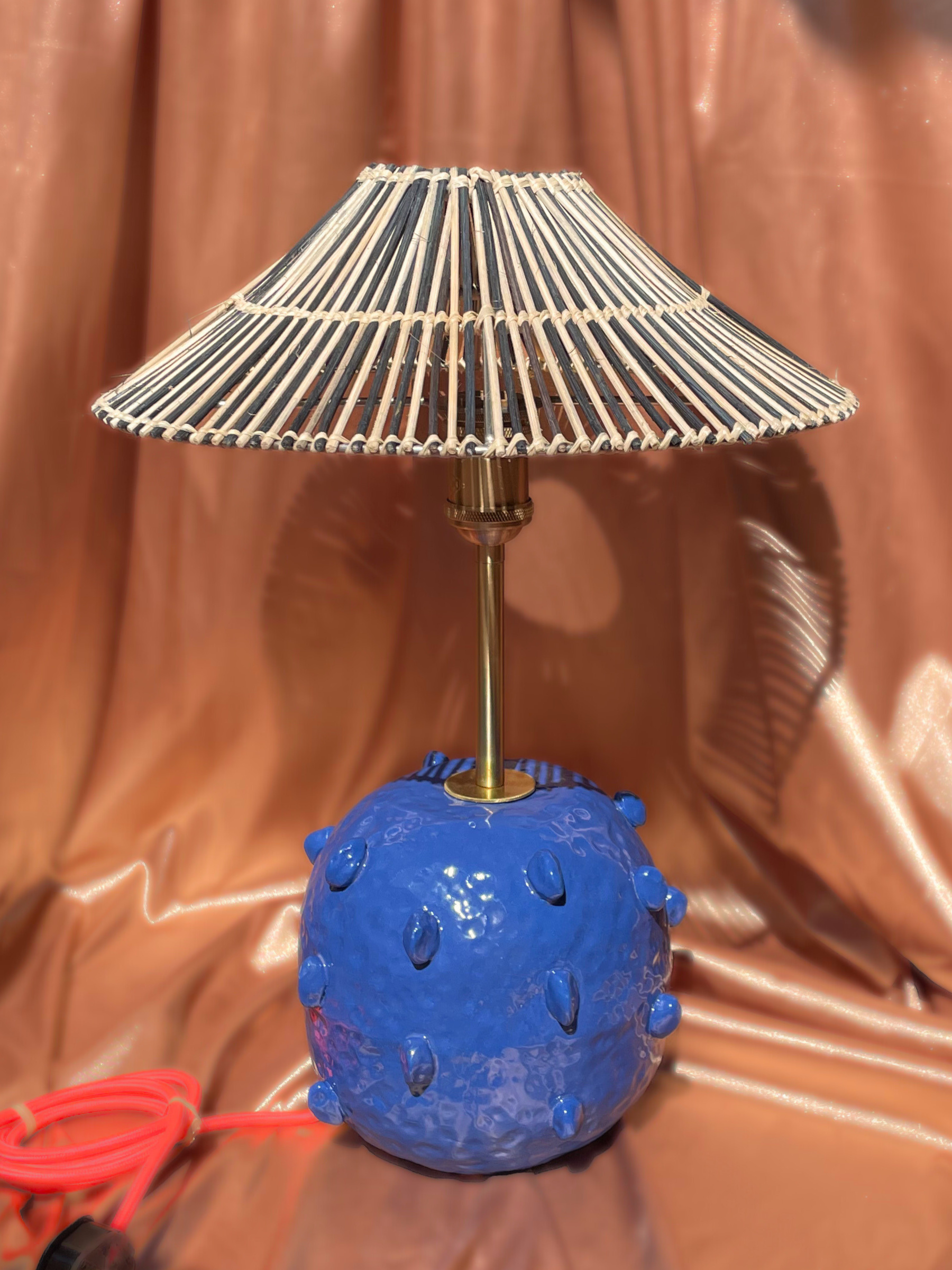 Blue textured lamp with a wicker shade 