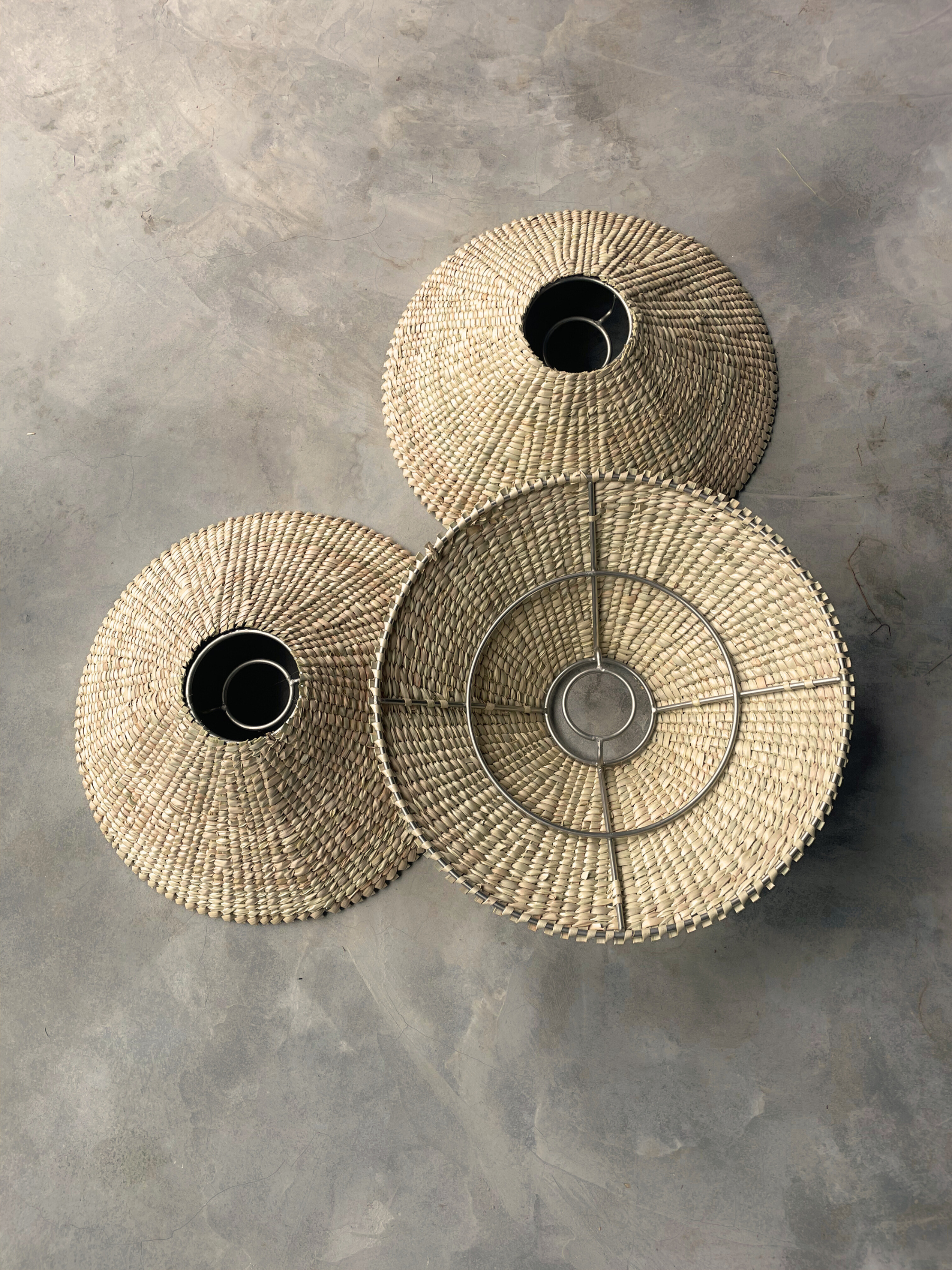 Three woven baskets lights of different sizes 
