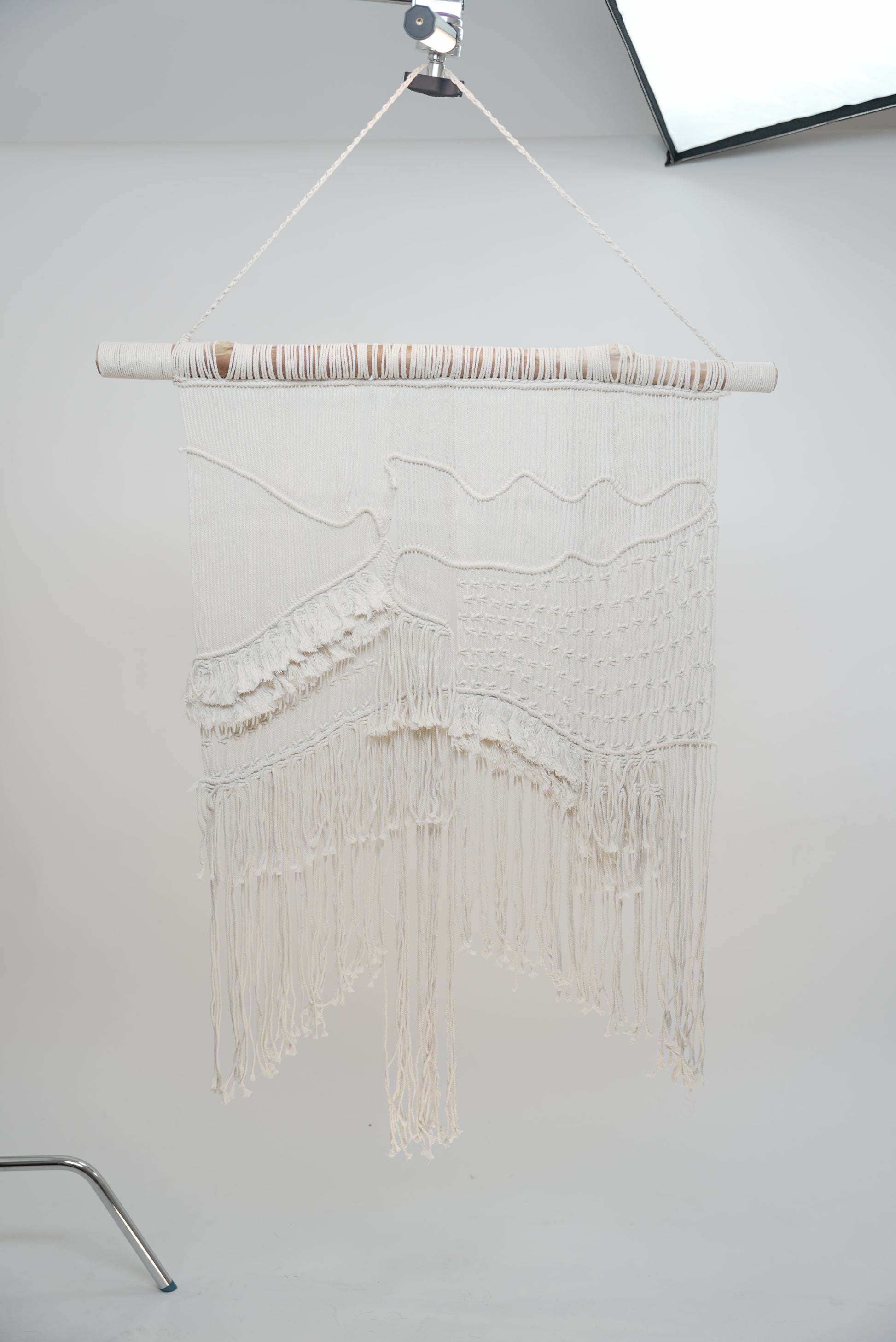 The Macrame wall hanger hand woven with crisp white macrame on a one of a kind wooden rod home decor soft furnishings
