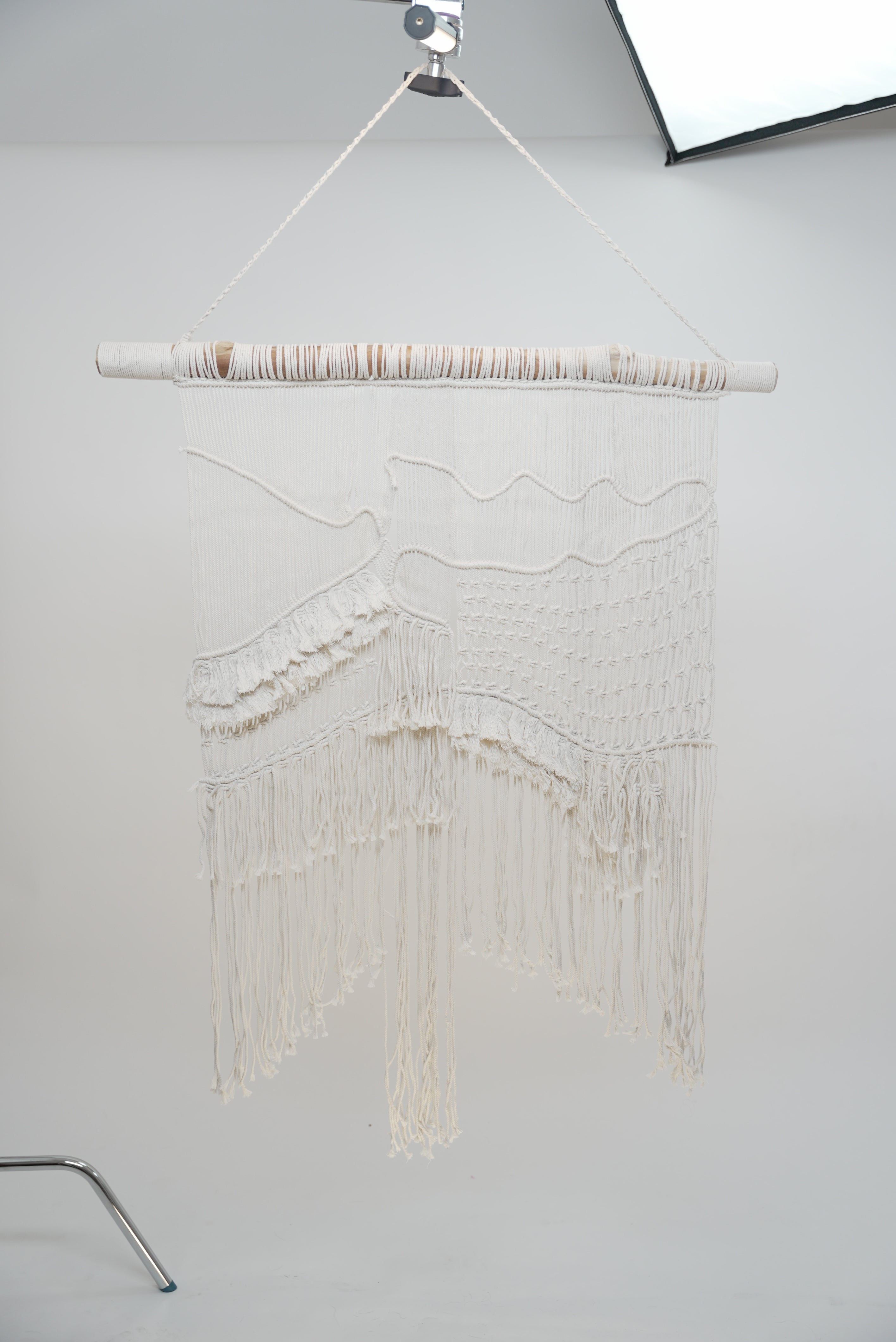 The Macrame wall hanger hand woven with crisp white macrame on a one of a kind wooden rod home decor soft furnishings