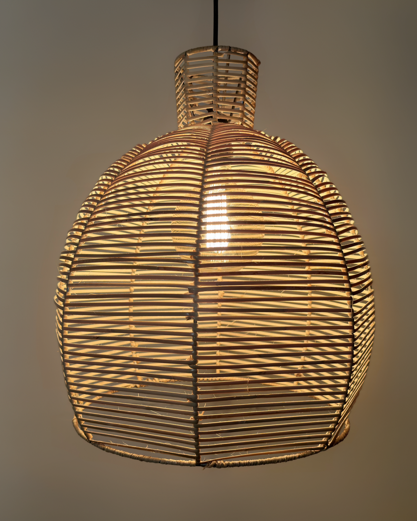 A ceiling-mounted chandelier with a stainless steel frame and tightly woven bamboo cane strips, creating a warm, ambient light. 