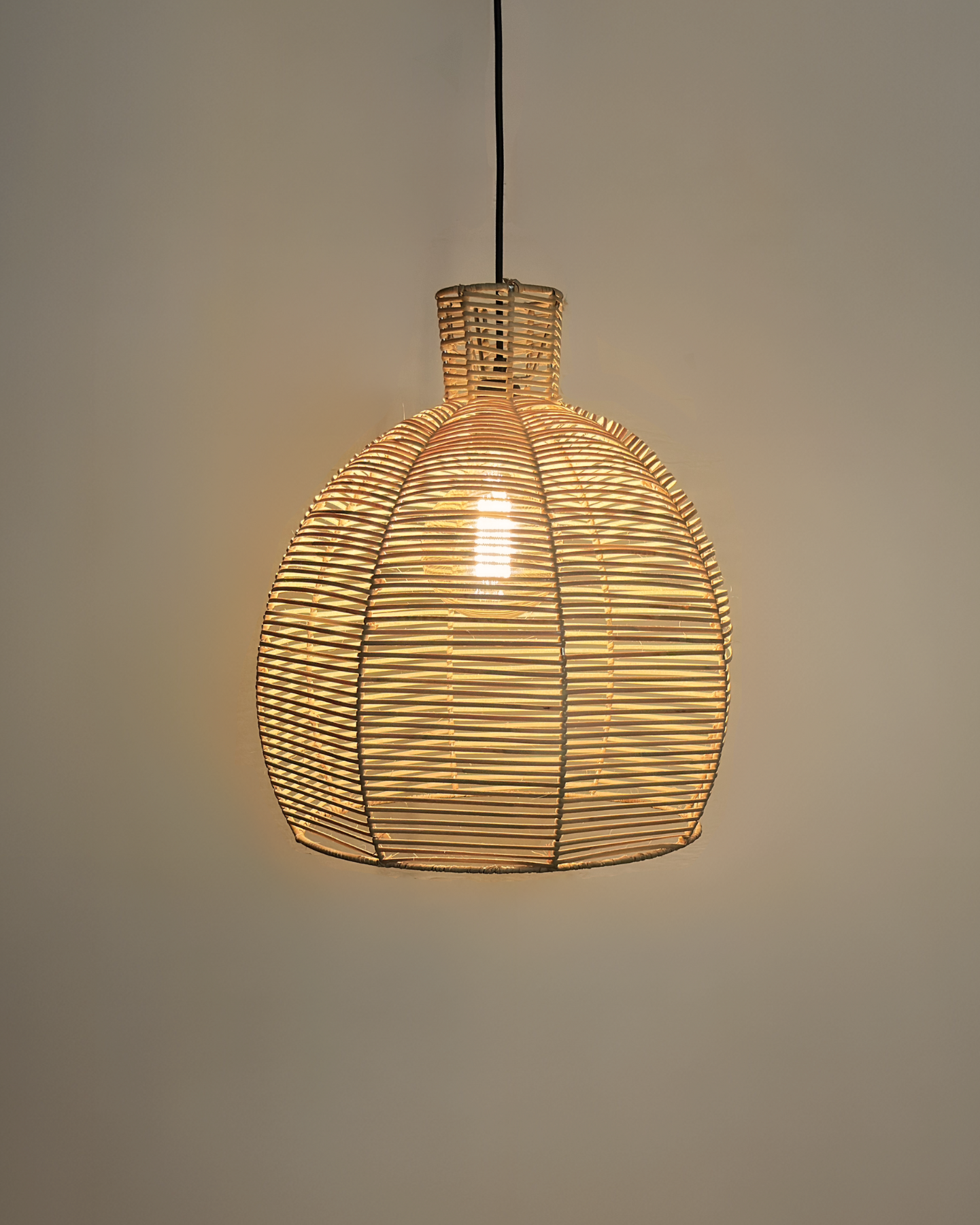 A ceiling-mounted woven hanging light with a stainless steel frame and tightly hand woven rattan peel strips, creating a warm, ambient light. All locally made, all customisable lighting.
