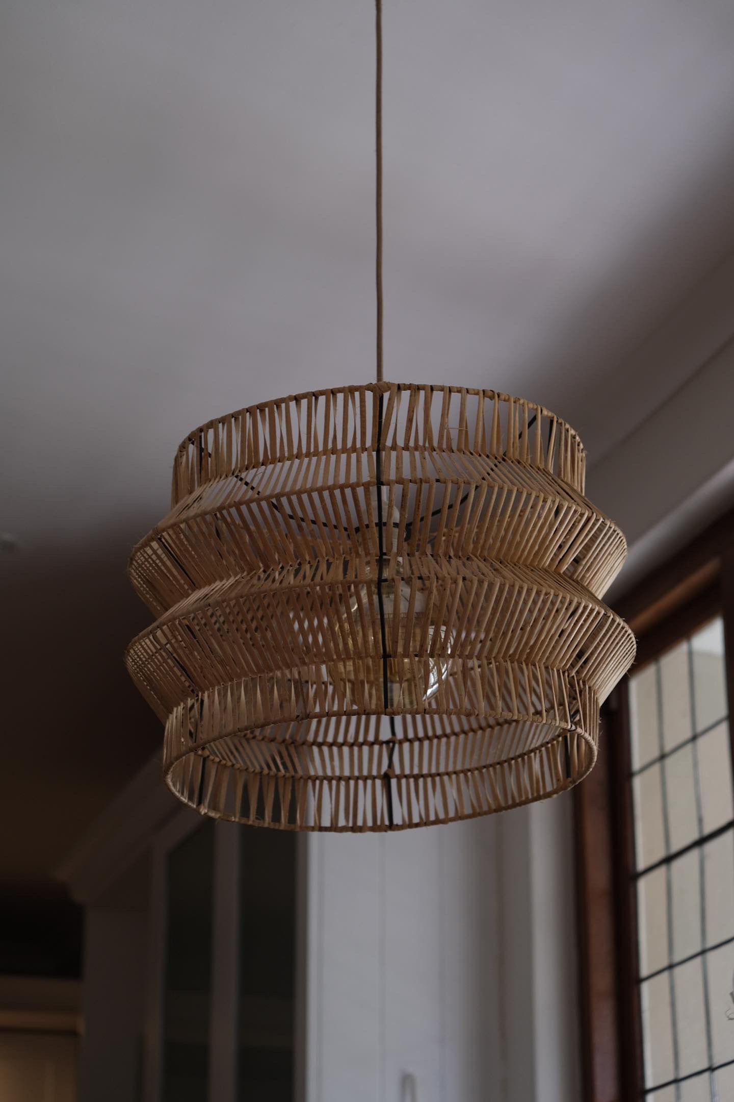 The Safari pendant hand woven on black powder coated frame from rattan peel, perfect for indoor and outdoor environments, hand woven, locally made, customisable. Great for resorts, hotels, restaurants, ambient lighting

