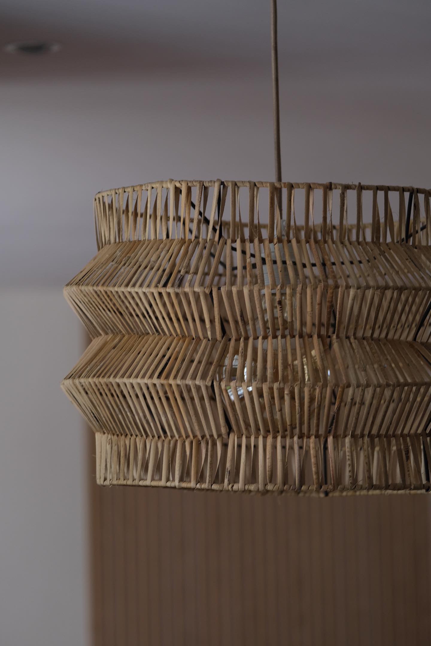 The Safari pendant hand woven on black powder coated frame from rattan peel, perfect for indoor and outdoor environments, hand woven, locally made, customisable. Great for resorts, hotels, restaurants, ambient lighting


