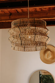 The Safari pendant on black powder coated frame from rattan peel, perfect for indoor and outdoor environments 
