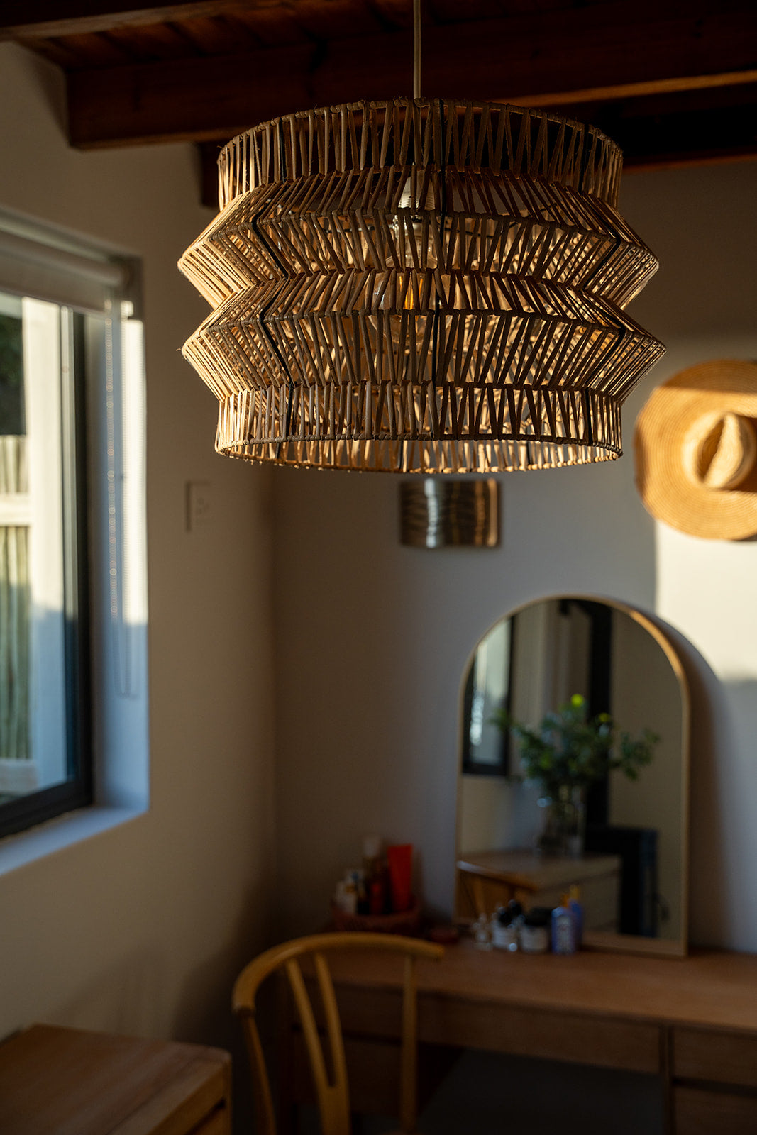 The Safari pendant on black powder coated frame from rattan peel, perfect for indoor and outdoor environments, hand woven, locally made, customisable

