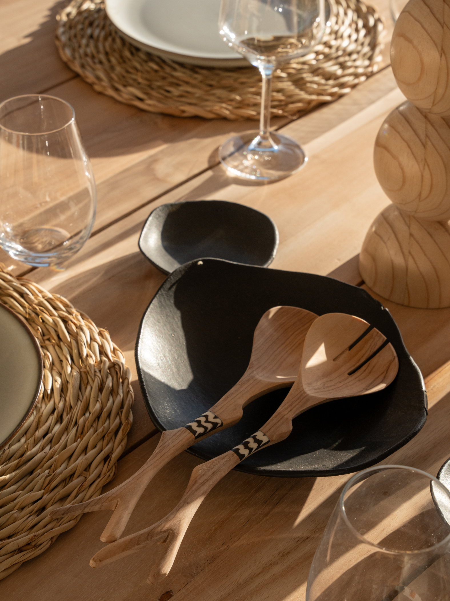 Our collection of plant oil polished Olive Wood salad servers with cattle bone from the Eastern Cape. Uniquely designed to suit modern environments that appreciate sustainable, classic, quality design. Patterns may vary. 