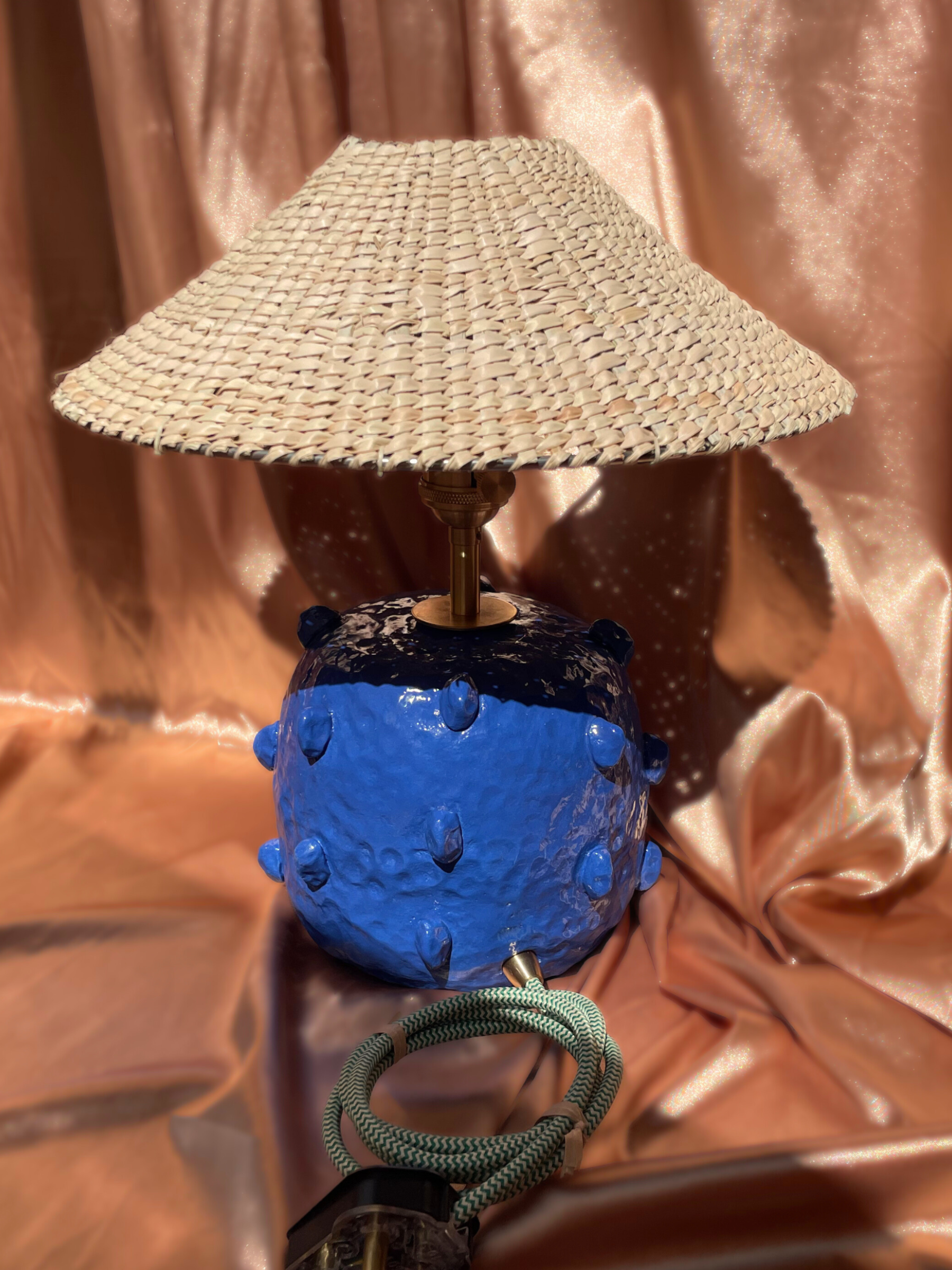 Lamp with a blue base and textured shade 