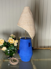 Lamp with a blue base and wicker shade  brass fixtures custom cord