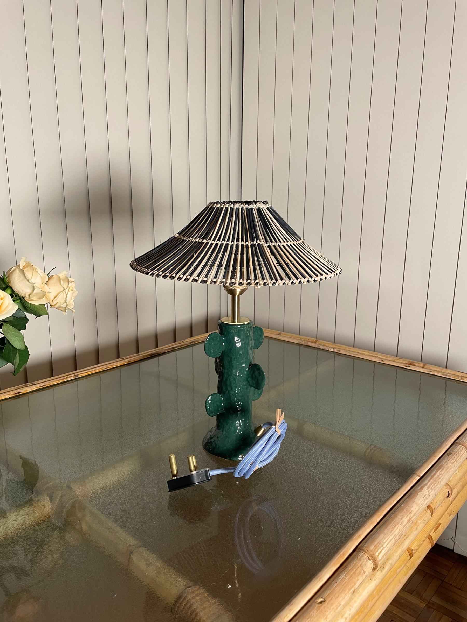 Green lamp with unique design on a glass table