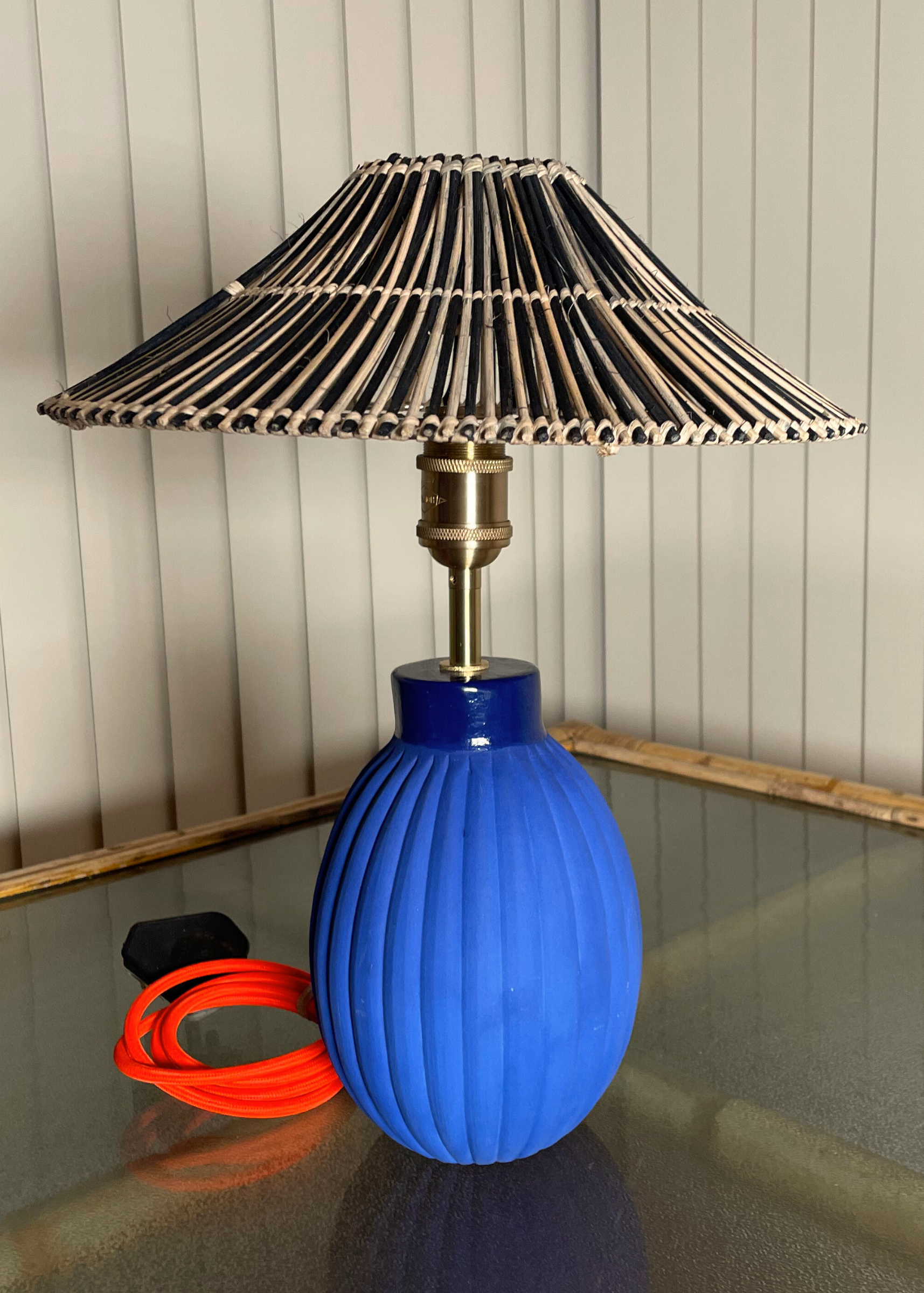 Blue handmade ceramic lamp base with a decorative cane wicker woven shade  brass fixtures custom cord