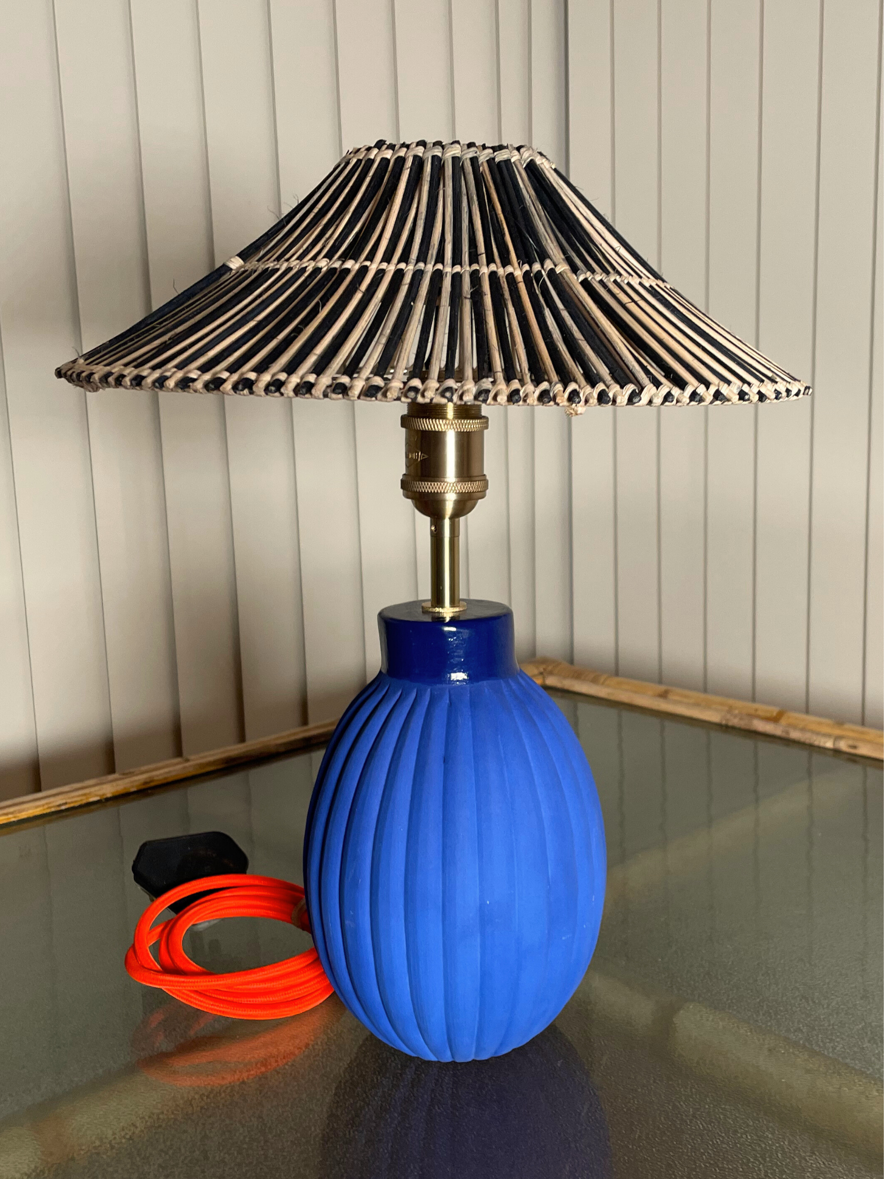 Blue handmade ceramic lamp base with a decorative cane wicker woven shade  brass fixtures custom cord