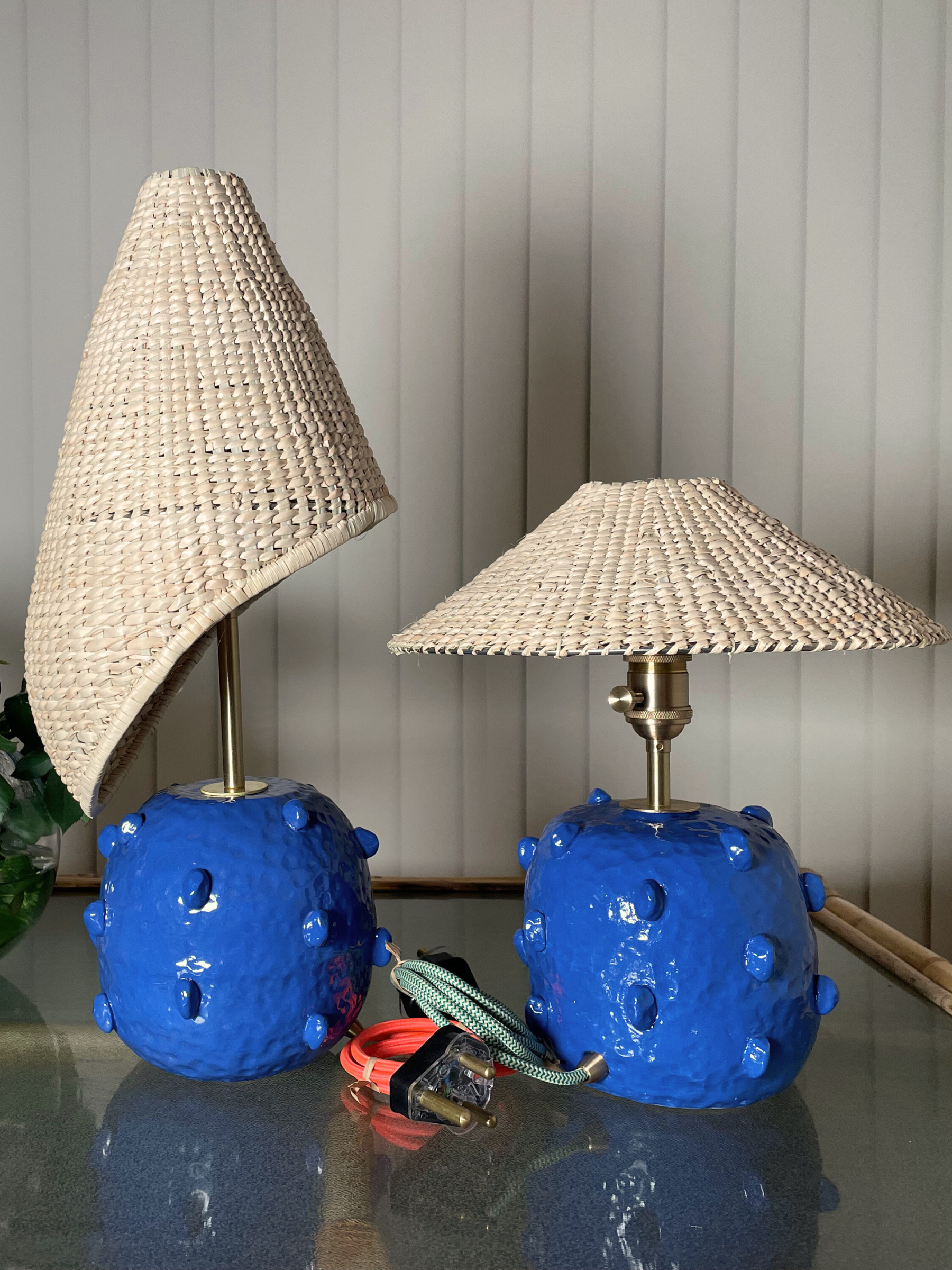 Two blue textured table lamps with wicker shades 