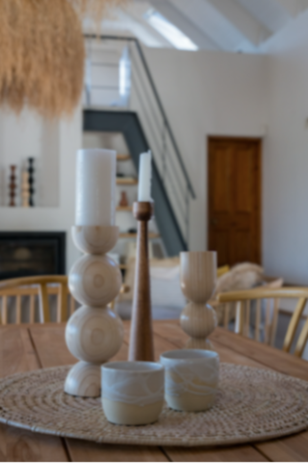 Decorative wooden candle holder set on a woven placemat