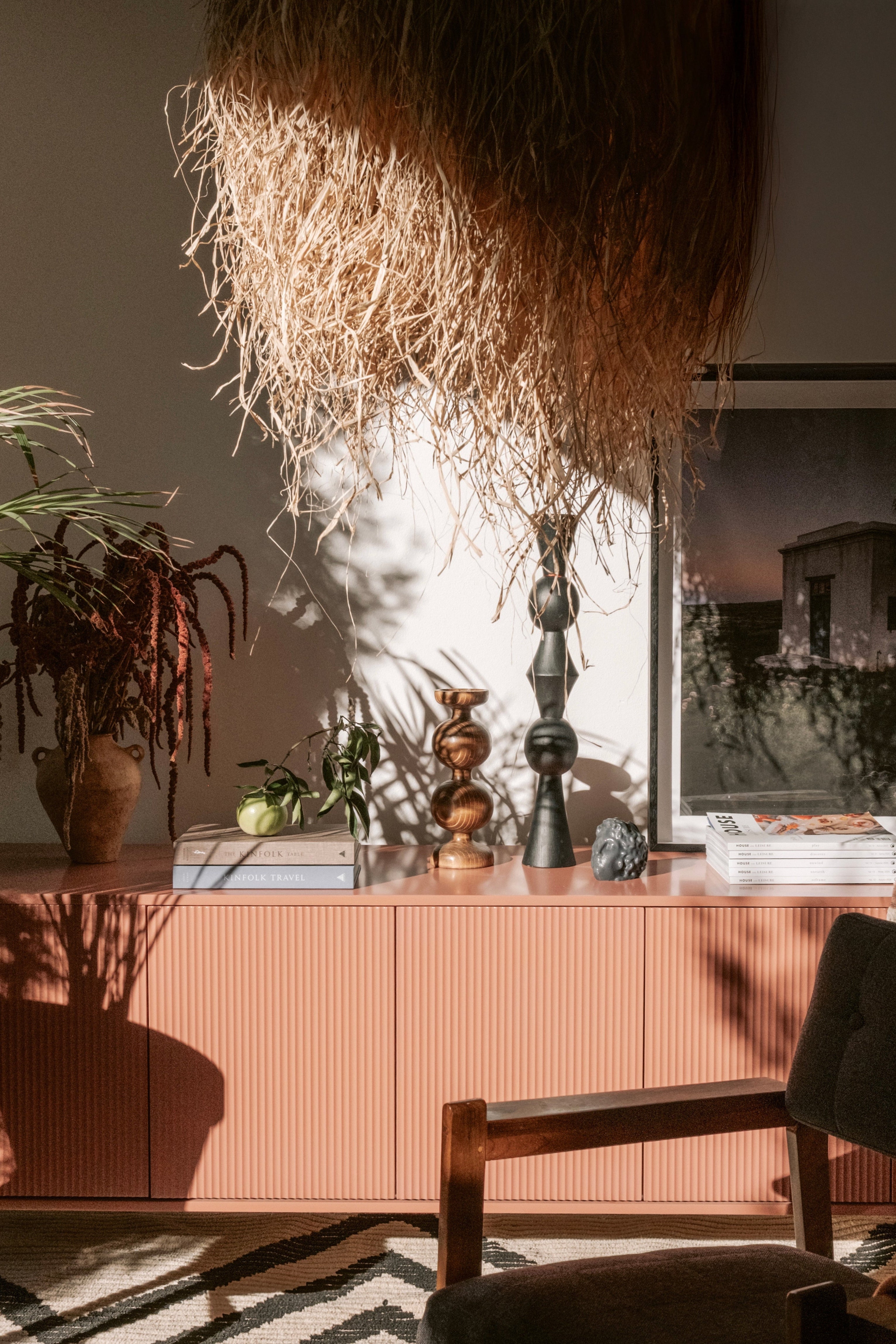 Modern interior with raffia ceiling light fixture and wood turned candle holders