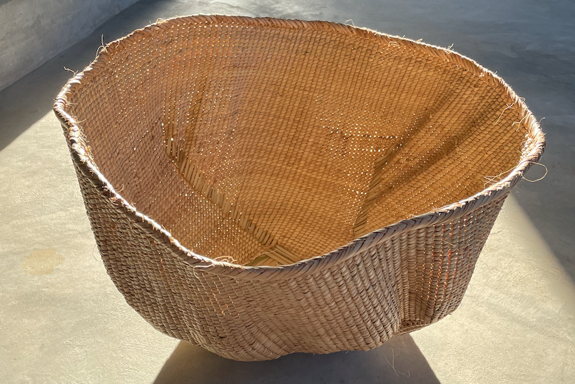 Ndebele woven wonky basket handmade from natural fibres for home decor, soft furnishings, lodges, restaurants, property developments and interior projects in various customisable sizes, in hues of brown, beige, and peach