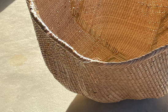 Ndebele woven wonky basket handmade from natural fibres for home decor, soft furnishings, lodges, restaurants, property developments and interior projects in various customisable sizes, in hues of brown, beige, and peach