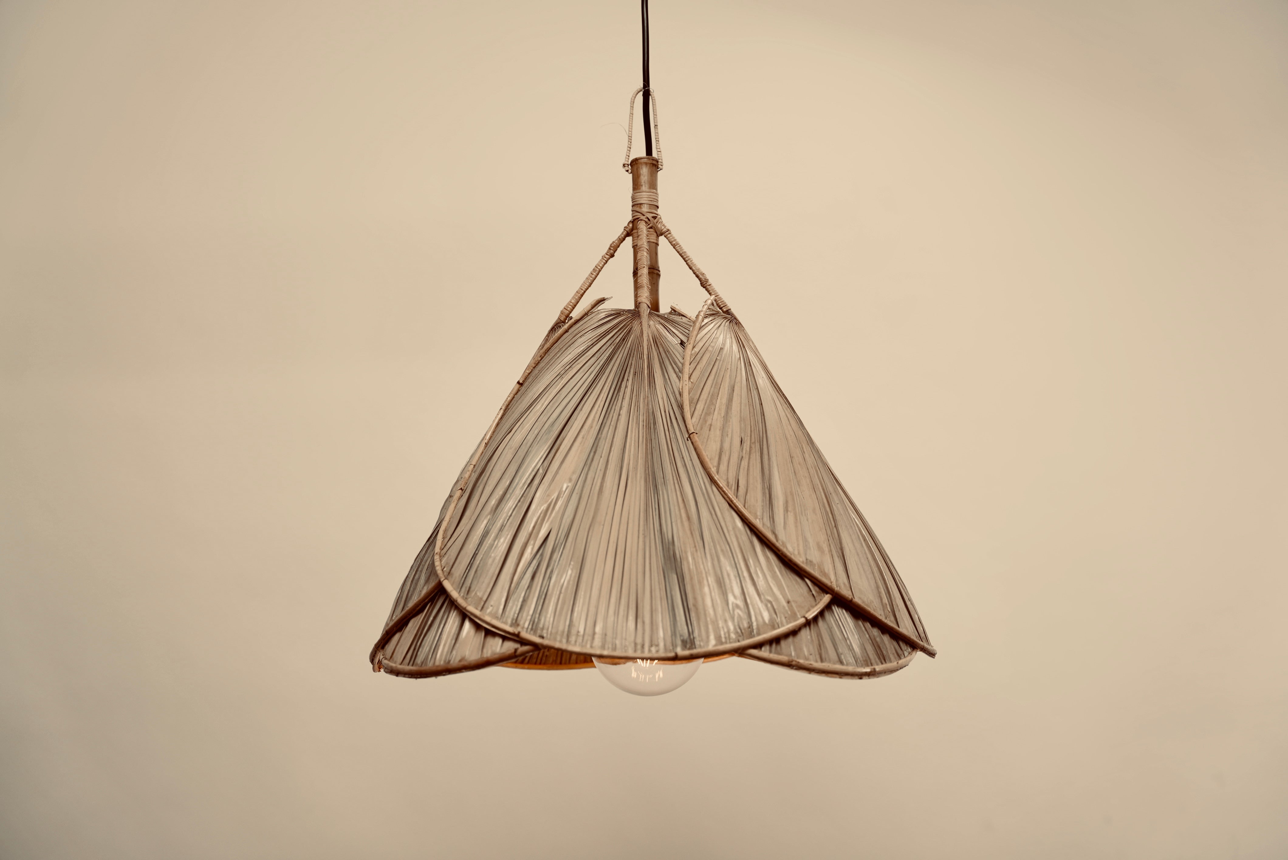 Two UFO pendants hanging above a table in a moody setting