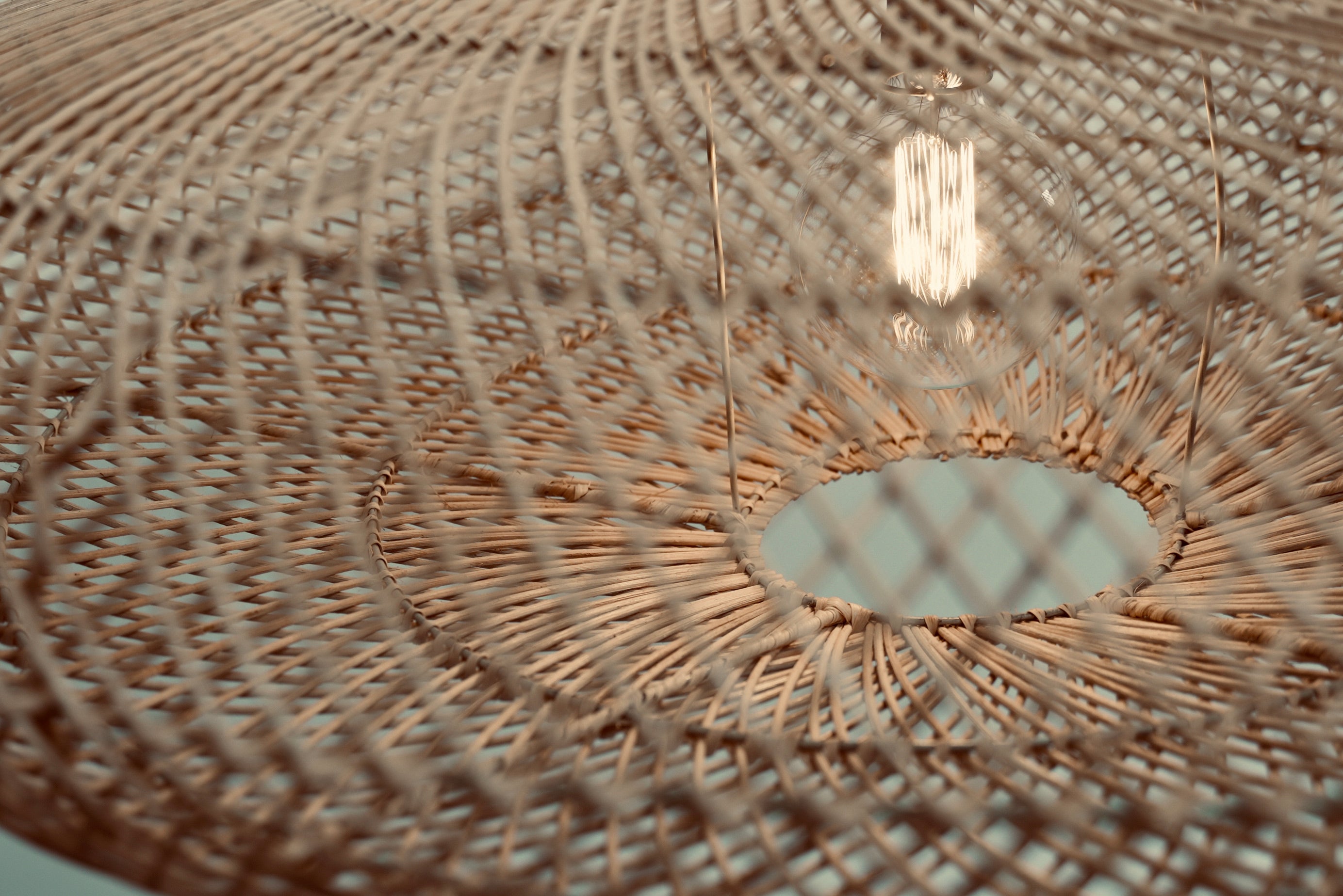 Two UFO pendants hanging above a table in a moody setting