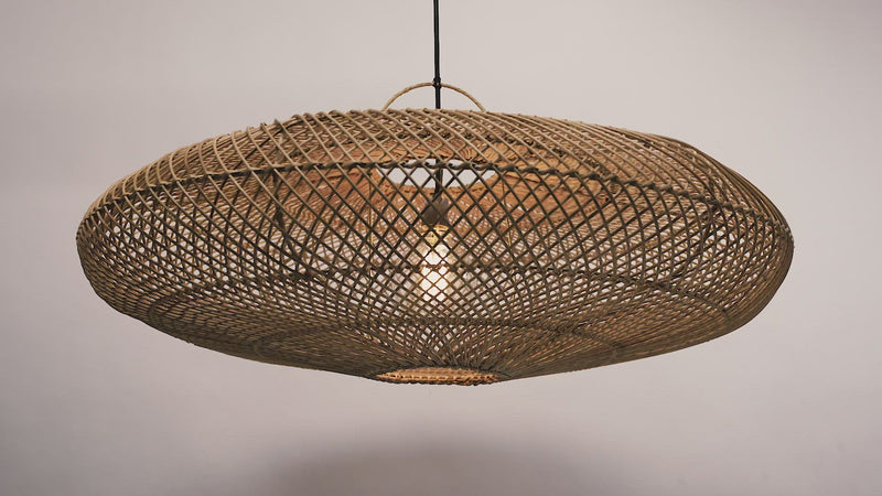 The UFO pendant hanging against a neutral background