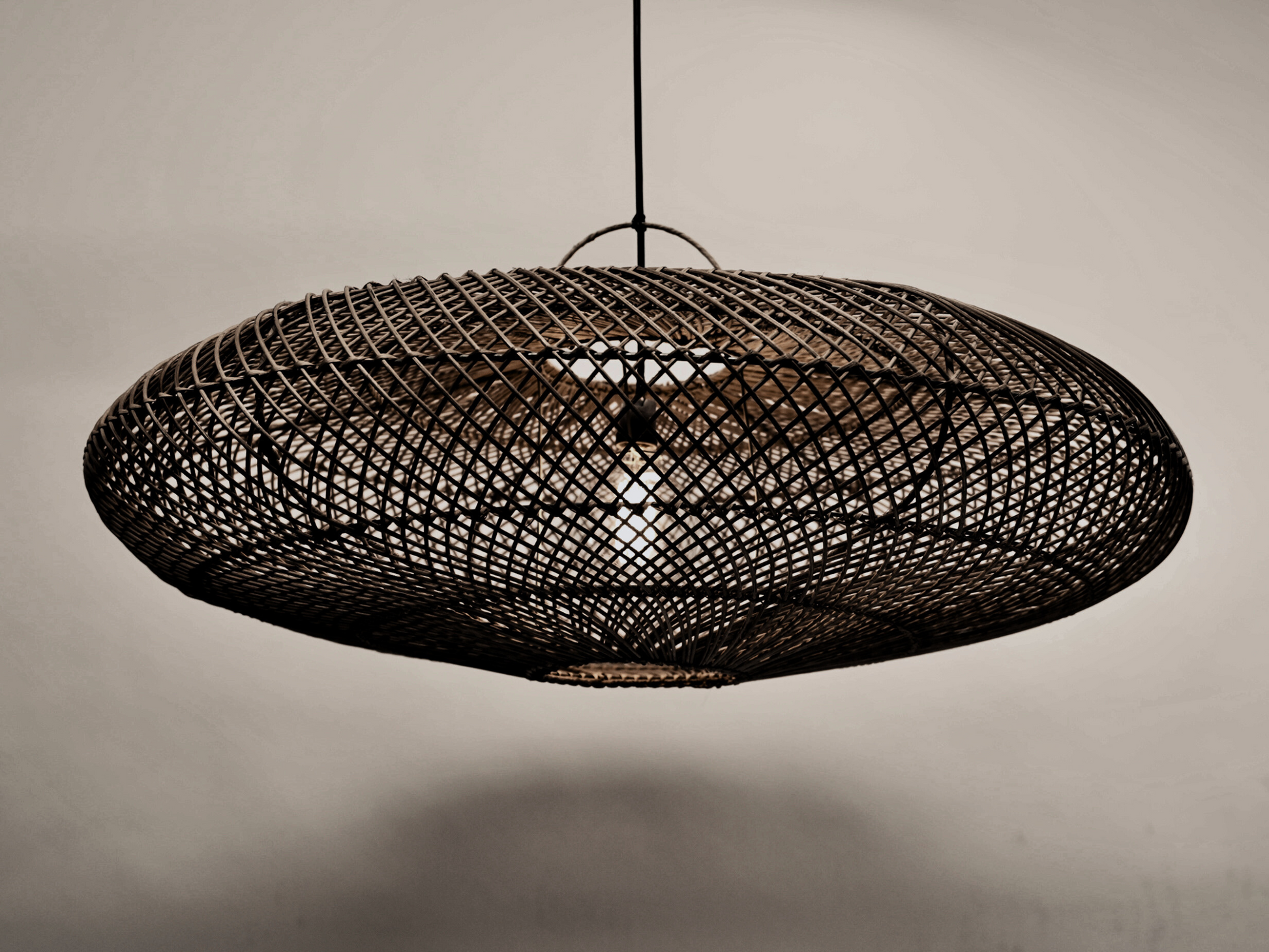 The UFO pendant in black variant on black powder coated stainless steel frame