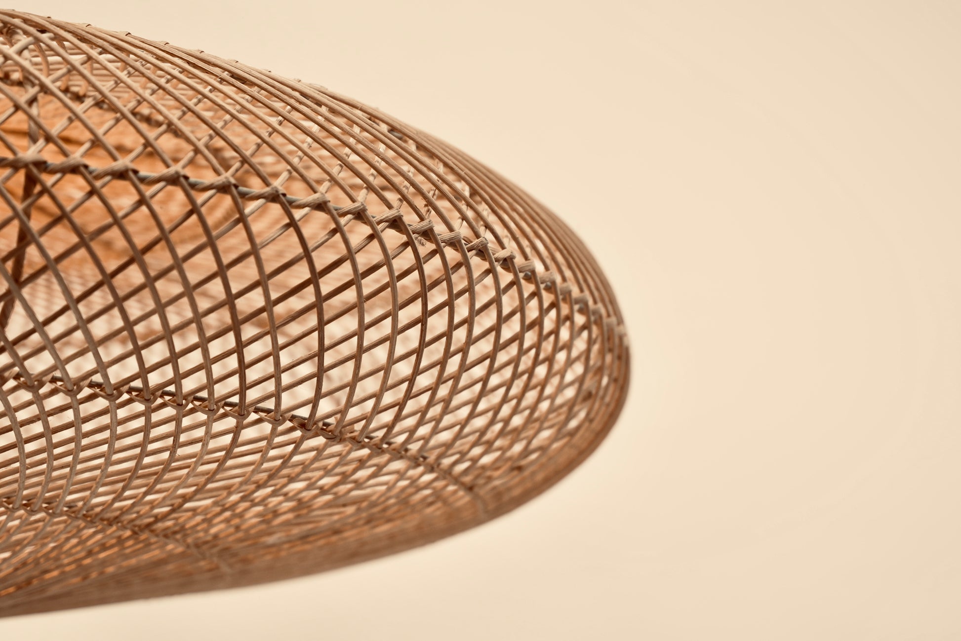 The UFO pendant woven with bamboo on stainless steel frame locally made and customisable in various sizes and colors from natural, black, or mixed