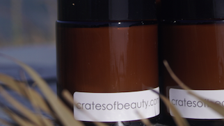 Close-up of soy candles in amber glass jars 