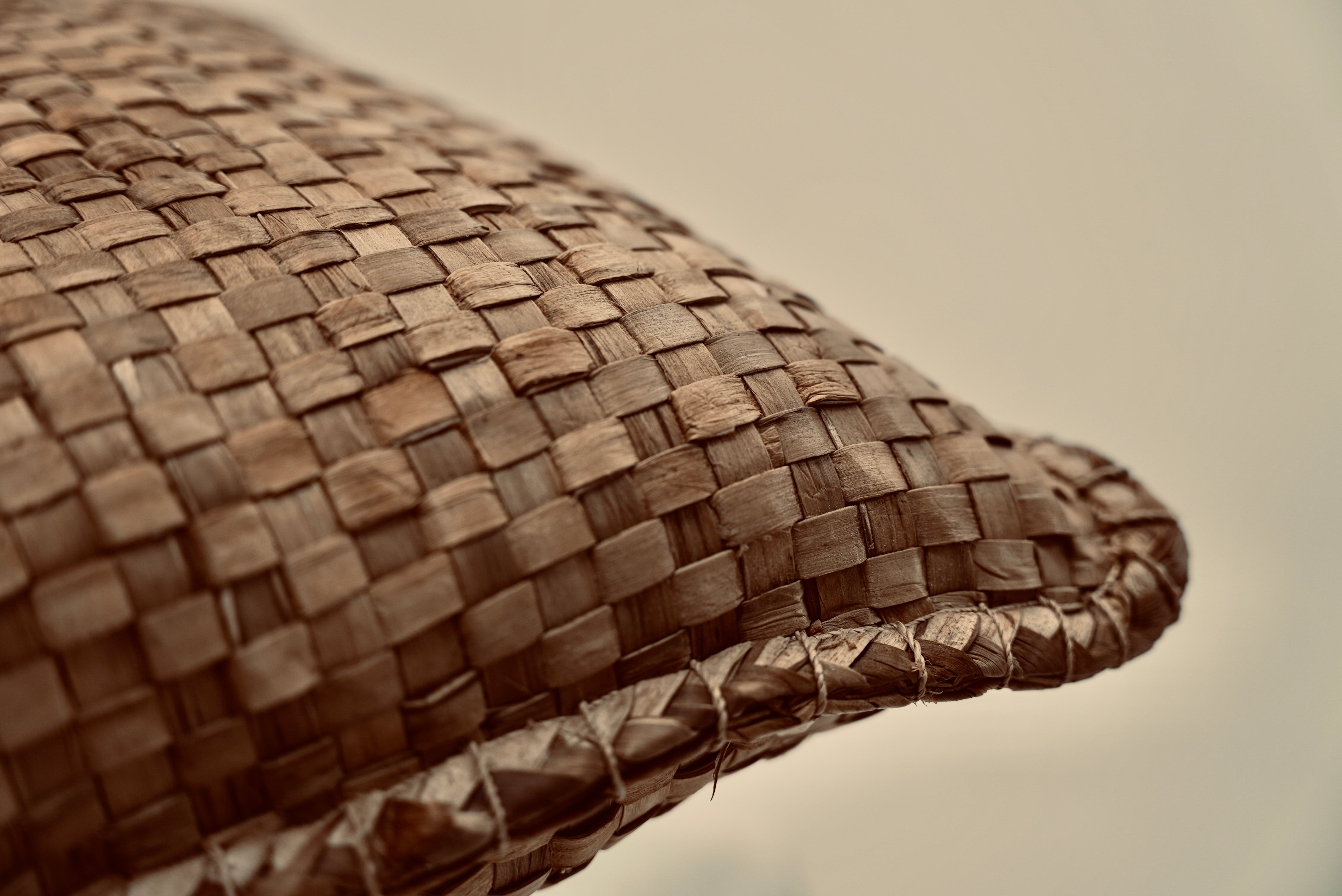 The crispy woven cushion woven from palm raffia with seagrass stitching