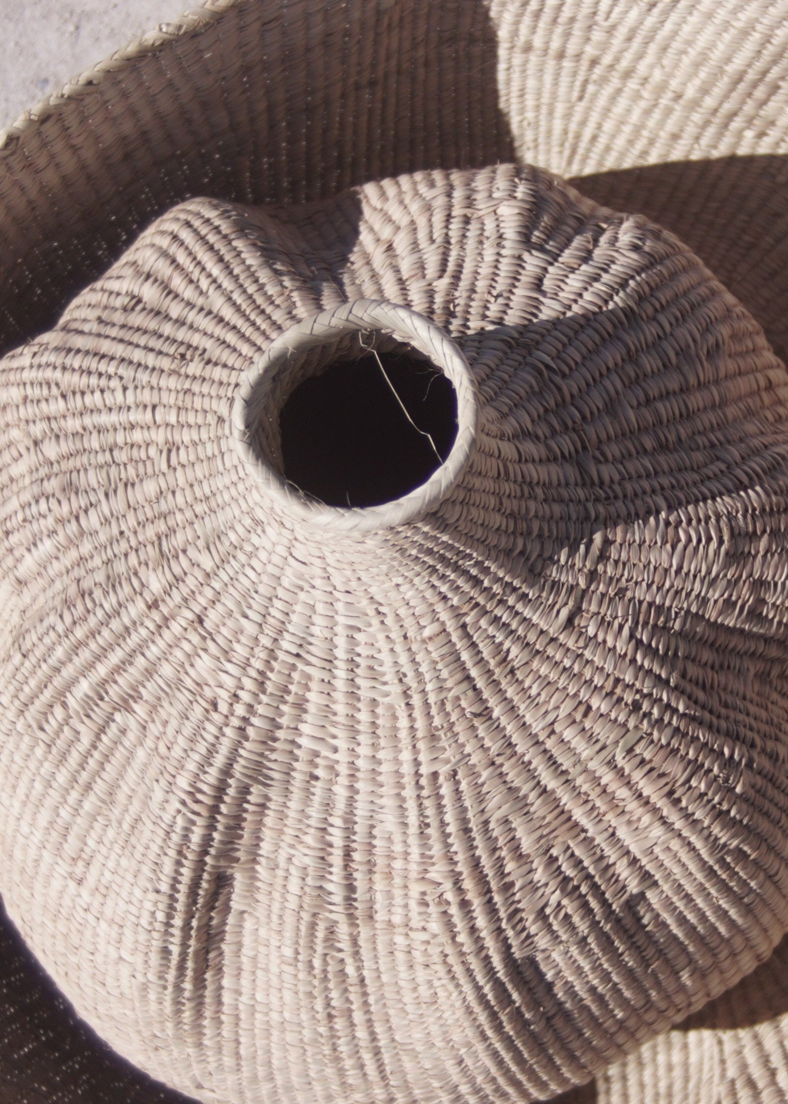 The garlic gourd photographed from above inside a wonky woven basket handmade home decor