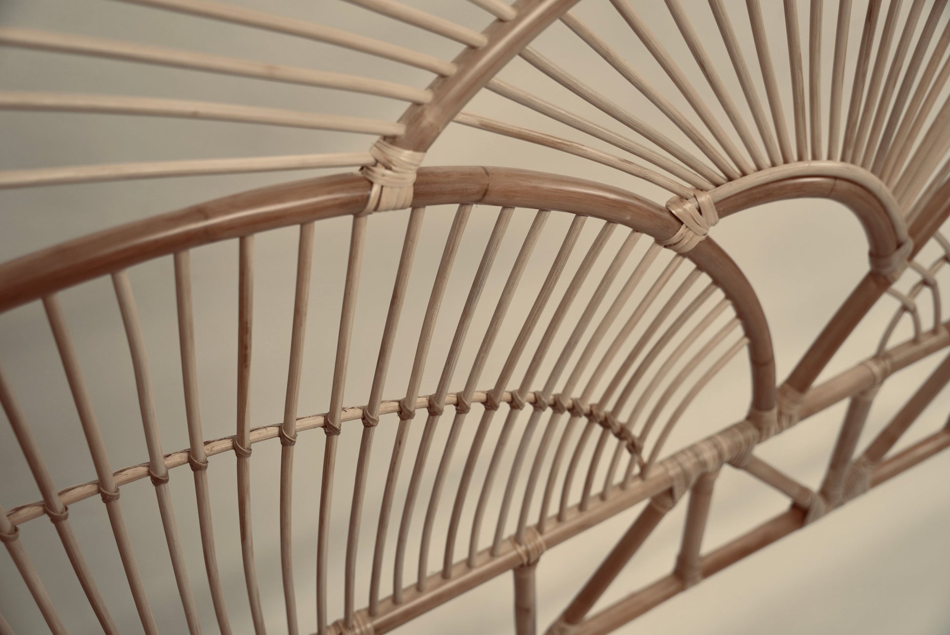 The Muji headboard photographed against a neutral wall showcasing the intricate curved details