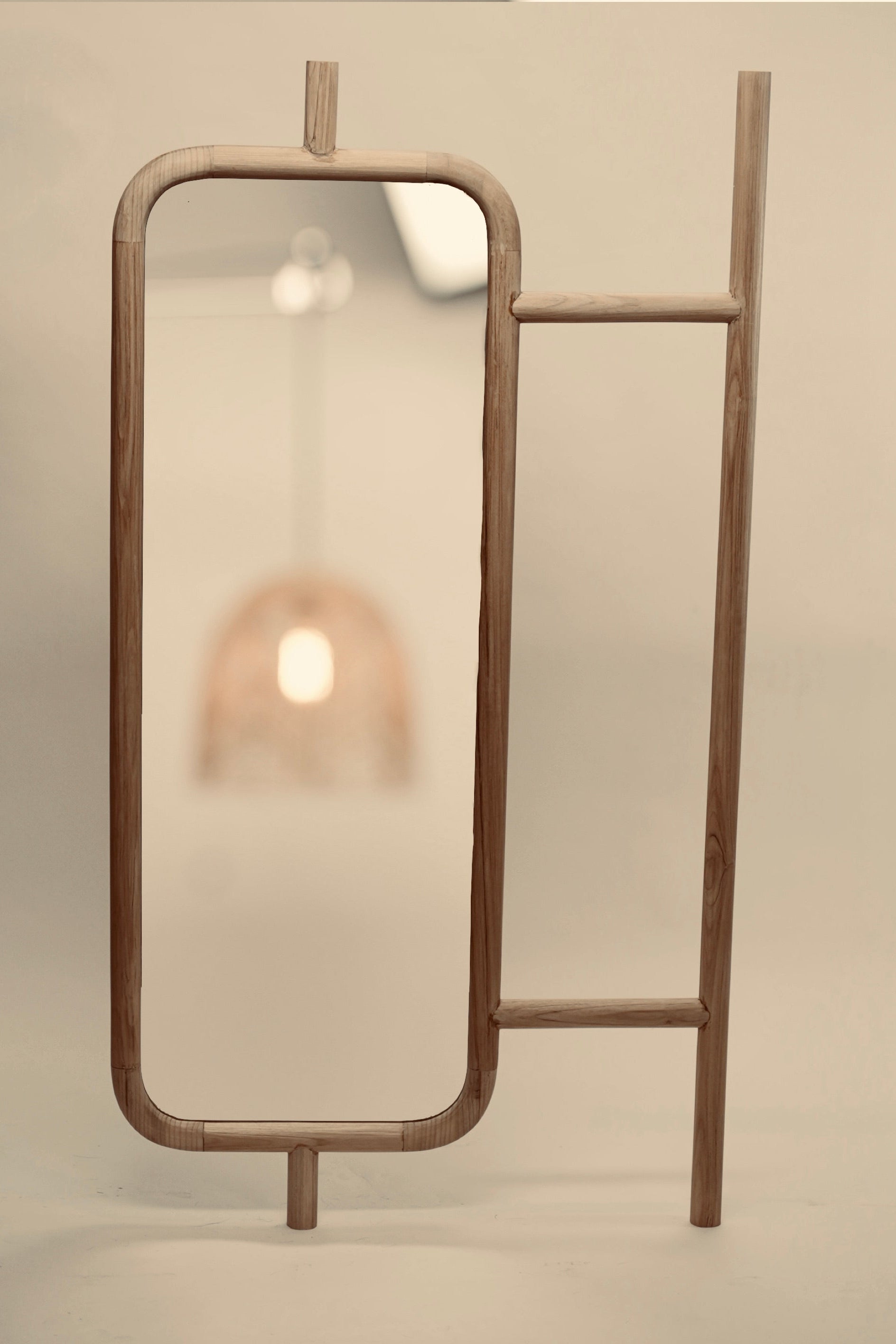 A close-up of the Muji mirror statement free standing minimalist home furnishings wooden mirror