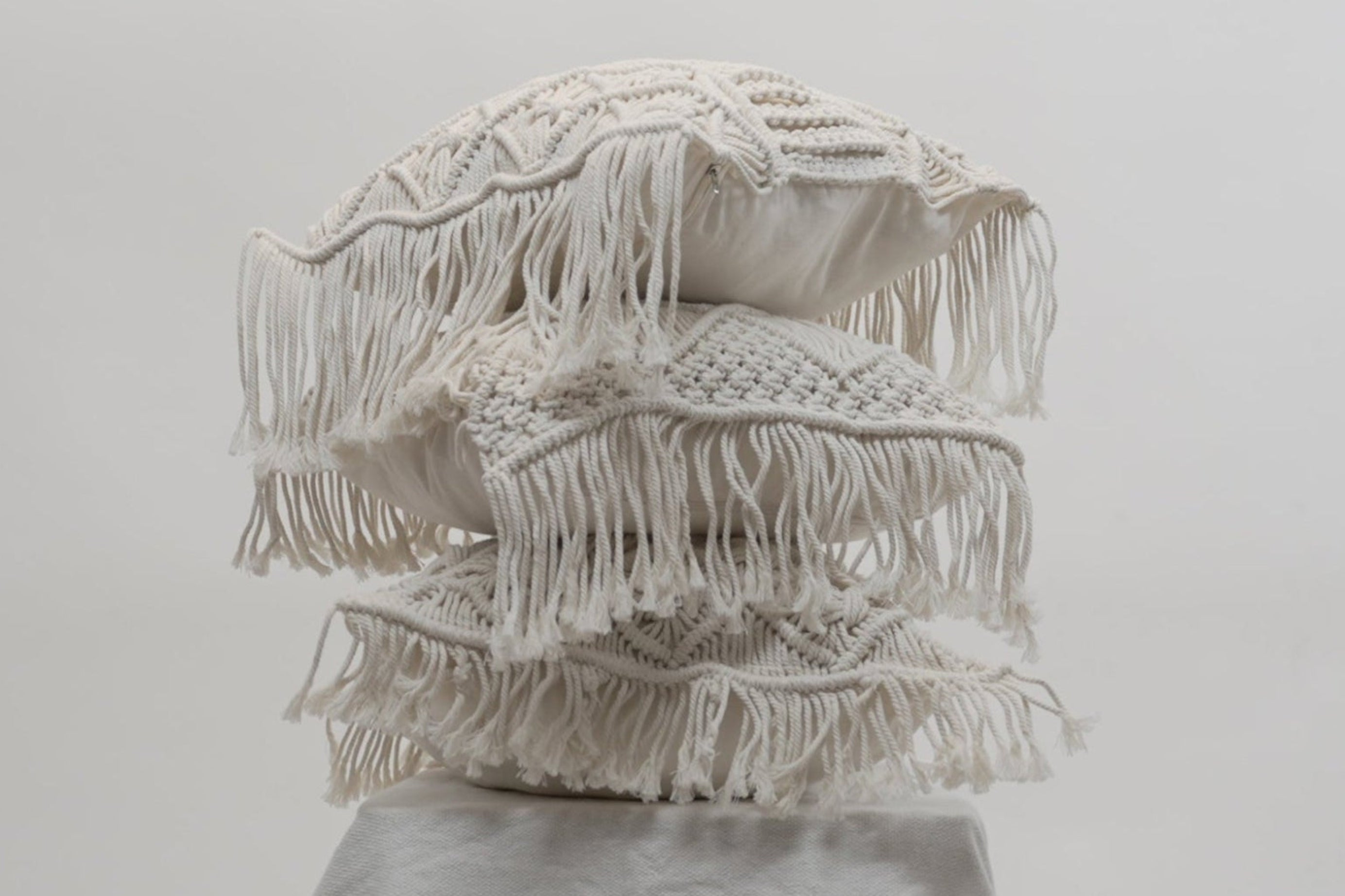 The macrame scatter cushions stacked on each other different variants