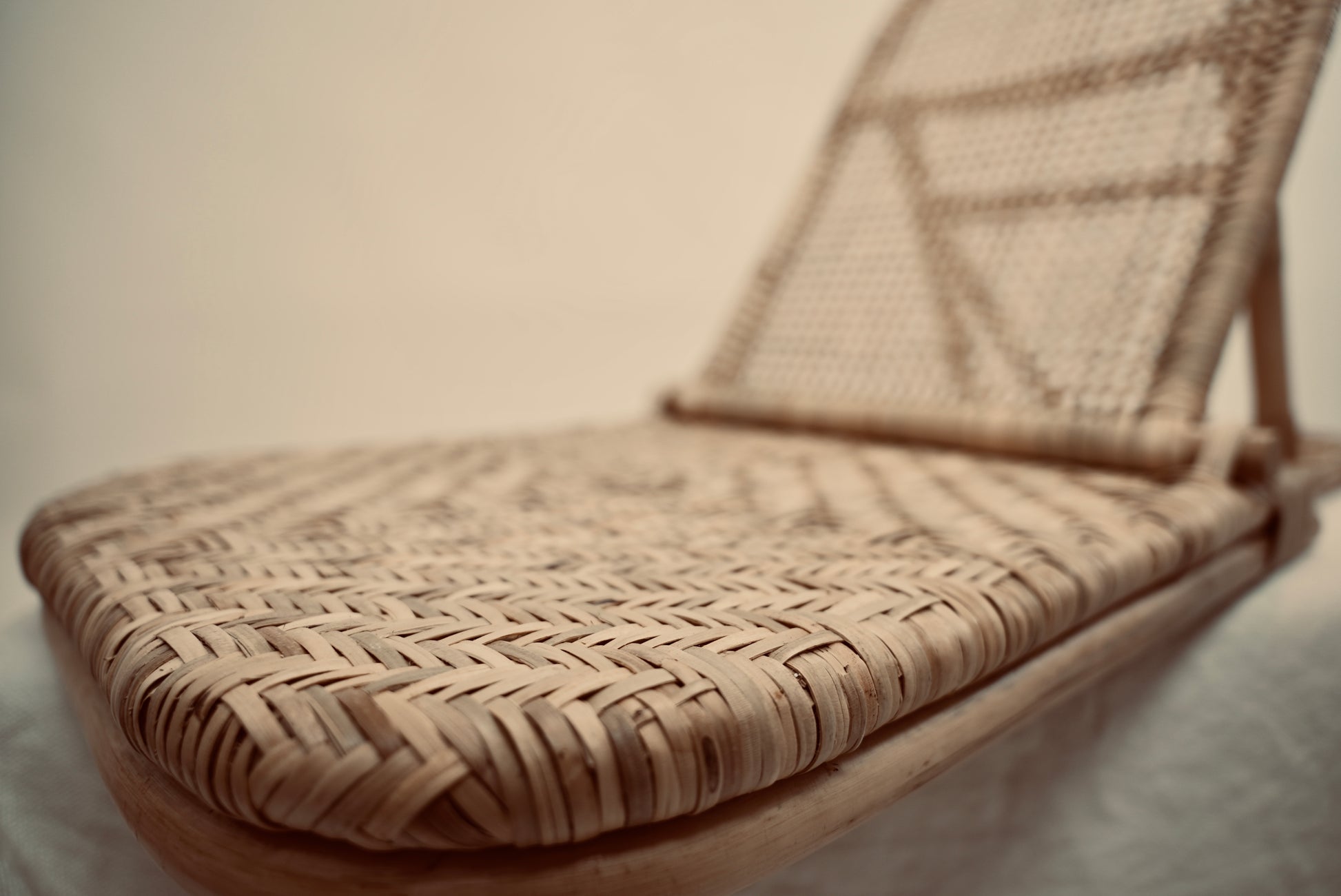 A close-up of the foldup Rattan beach chair handmade for luxury outdoors