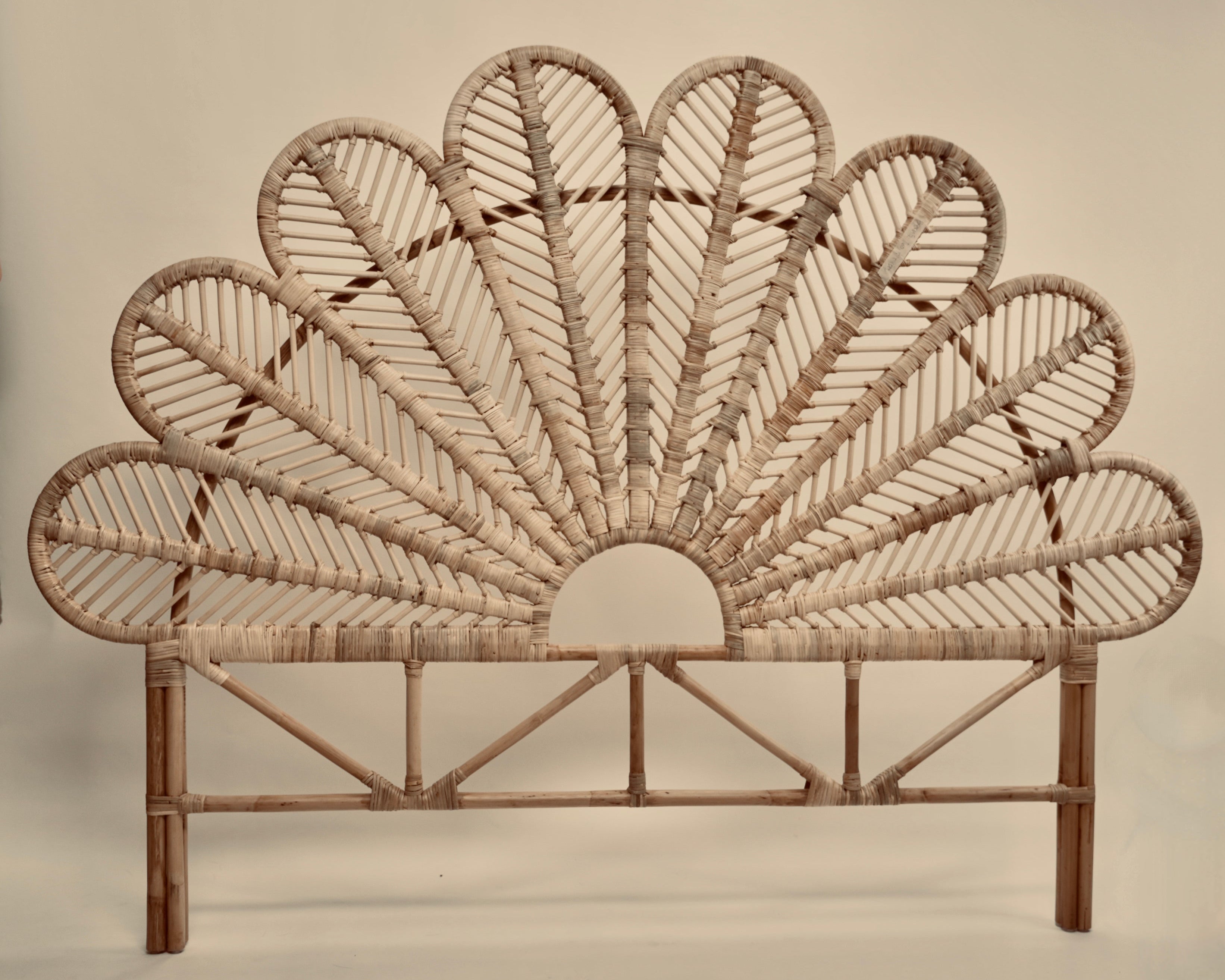 The Rattan Ibu headboard photographed against a neutral headboard