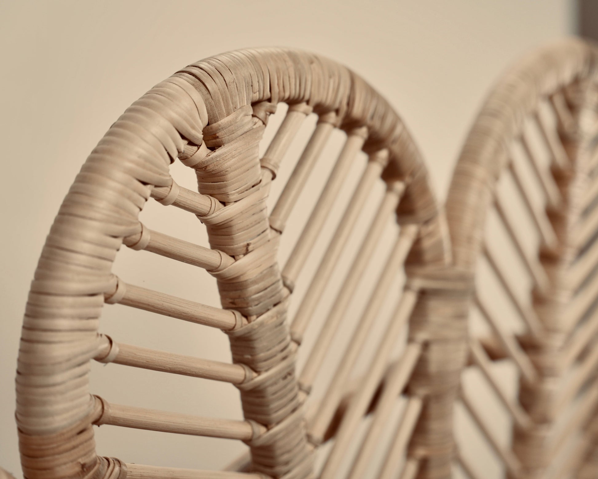 A close-up of the Rattan Ibu headboard photographed against a neutral headboard