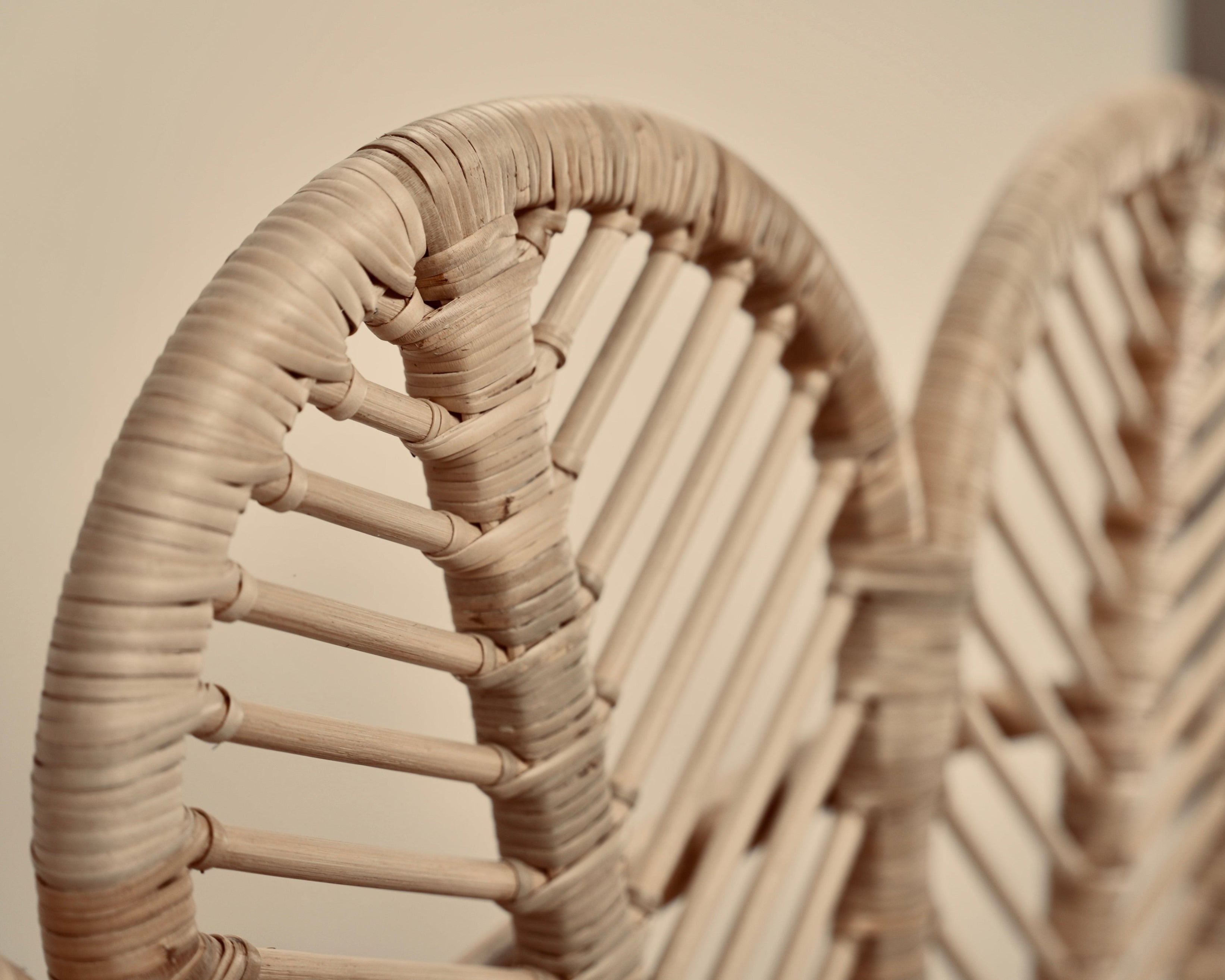 A close-up of the Rattan Ibu headboard photographed against a neutral headboard